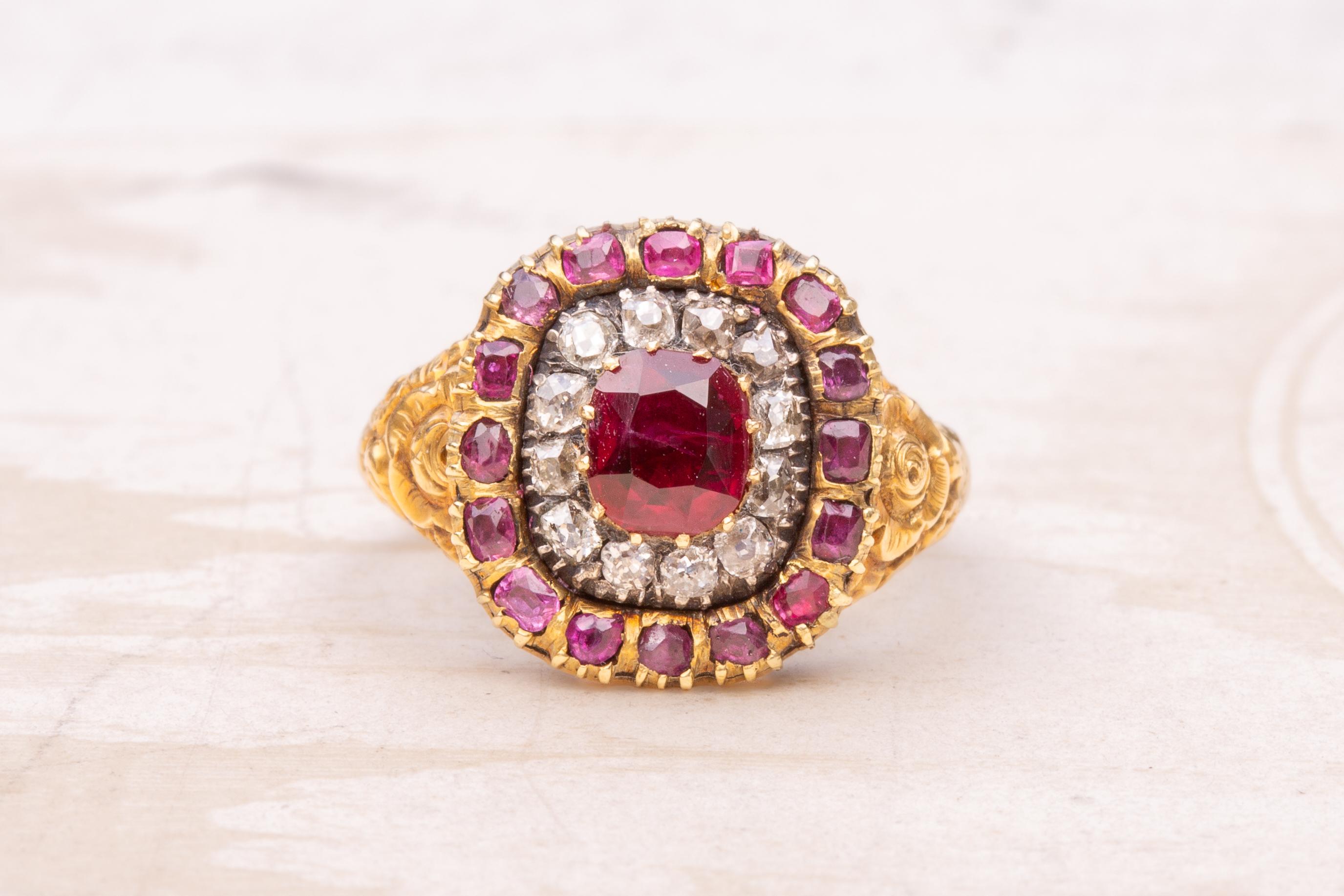 A superb antique Georgian ruby and diamond ring made in England, circa 1820. The centre of this ‘target’ shaped cluster ring is set with a 1ct cushion cut deep red ‘pigeon’s blood’ ruby, probably Burmese origin. Neatly prong-set, it is encircled by