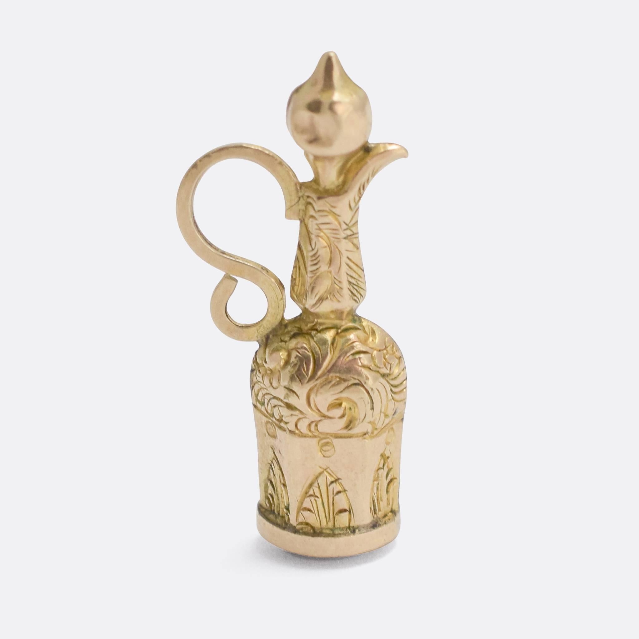 An unusual Georgian fob pendant, modelled as an oriental coffee jug (or similar). It's crafted from 9k gold, finely hand chased, and features a sardonyx panel to the base. It looks great as a simple pendant, or an addition to your charm