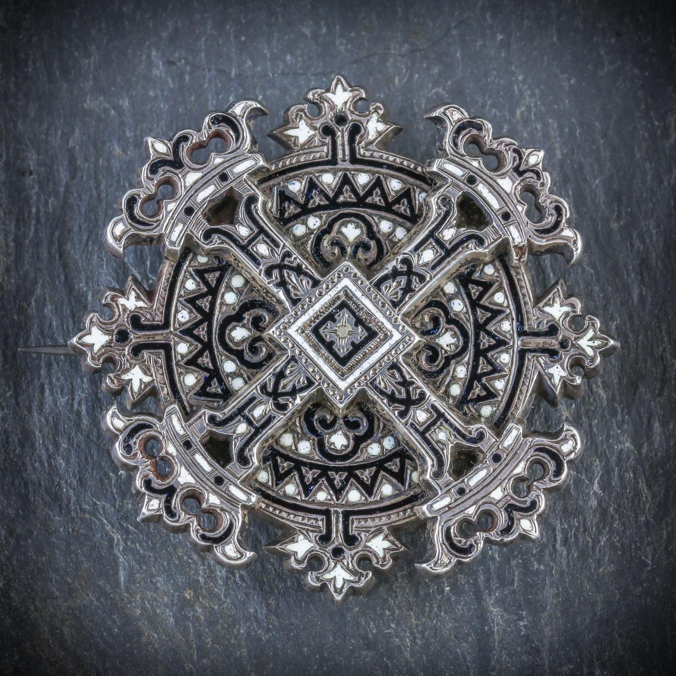 This unique Silver cross brooch is Georgian, Circa 1800

The brooch displays beautiful black and white enamel detailing with a large cross in the centre topped with four beautiful crowns

The brooch is set in Silver and fitted with a secure pin and