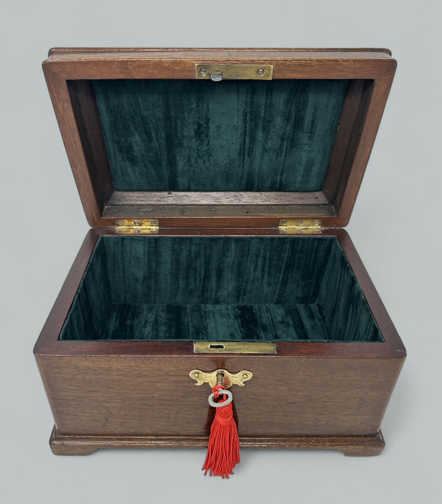 An exceptionally fine quality example of a Lady’s or Gentleman’s English Georgian or early Regency Period polished well figured Mahogany Jewlery or Sewing Casket or Table Box made during the first quarter of the Nineteenth Century. Raised on its