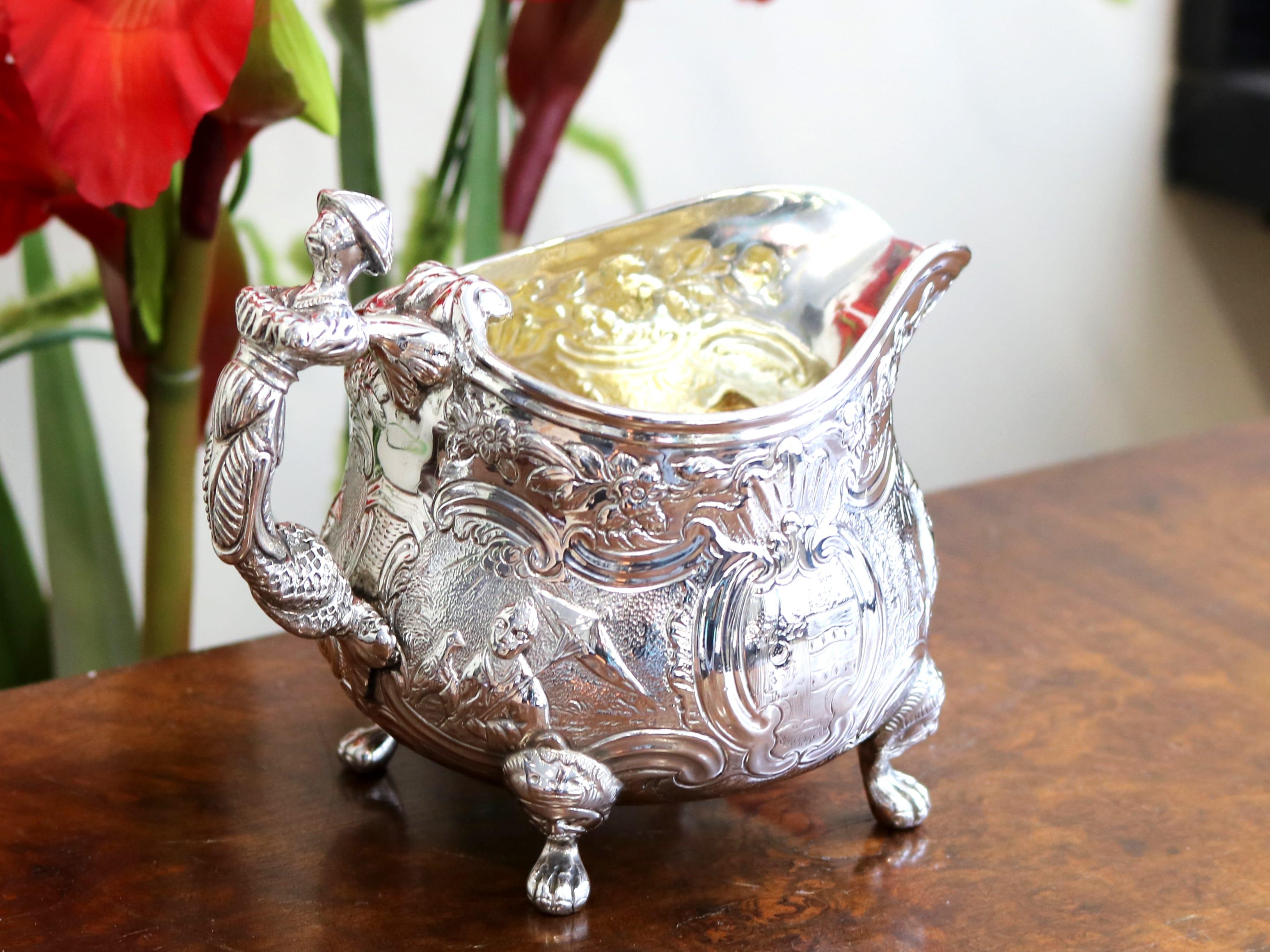 An exceptional, fine and impressive antique Victorian English sterling silver cream jug; an addition to our silver teaware collection.

This exceptional antique George III silver cream jug, in sterling standard, has a rounded helmet shaped