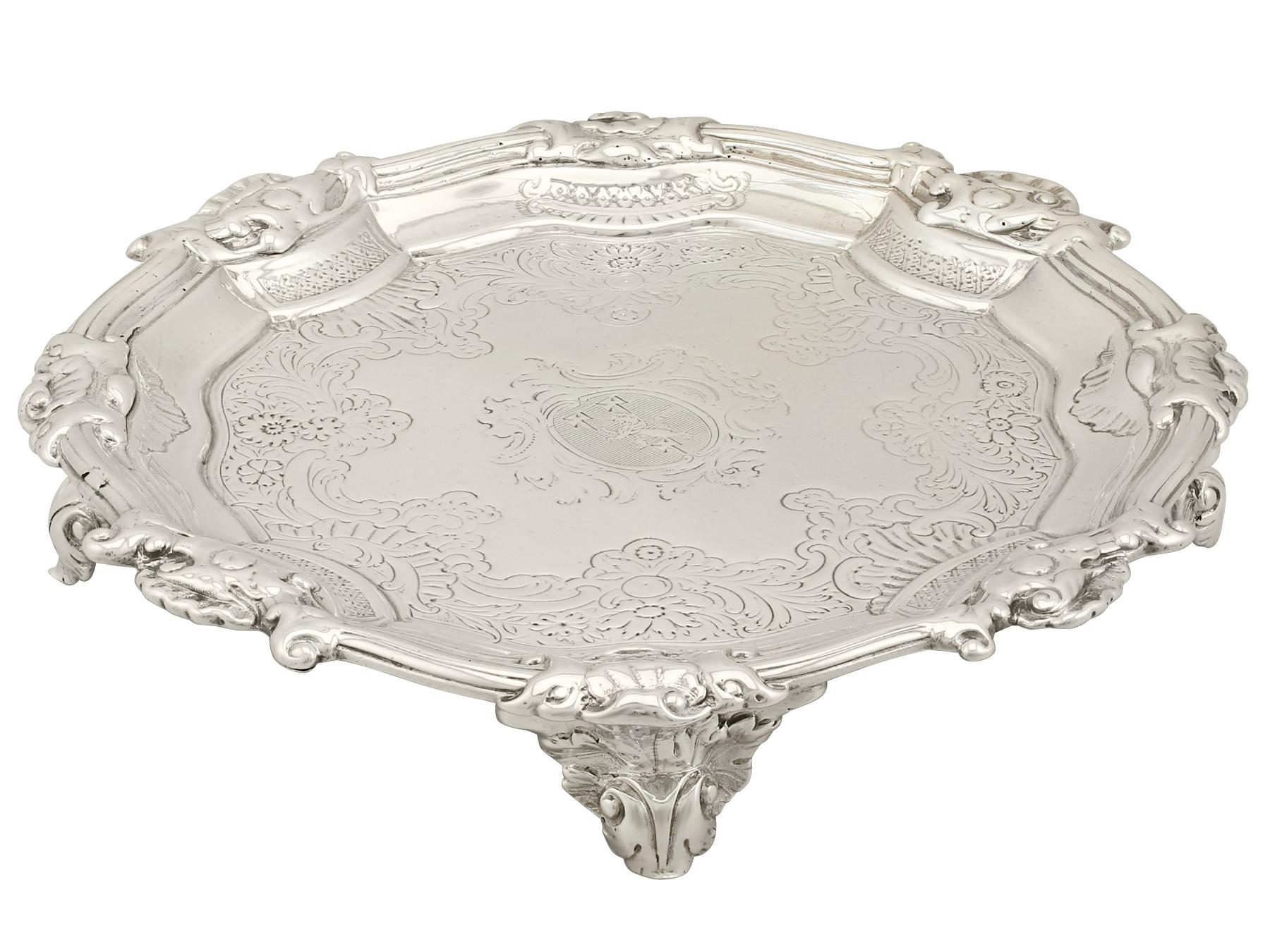 A fine and impressive antique George II English sterling silver waiter; an addition to our Georgian silverware collection.

This fine antique George II sterling silver waiter has a circular shaped form.

The surface of the well is encircled with