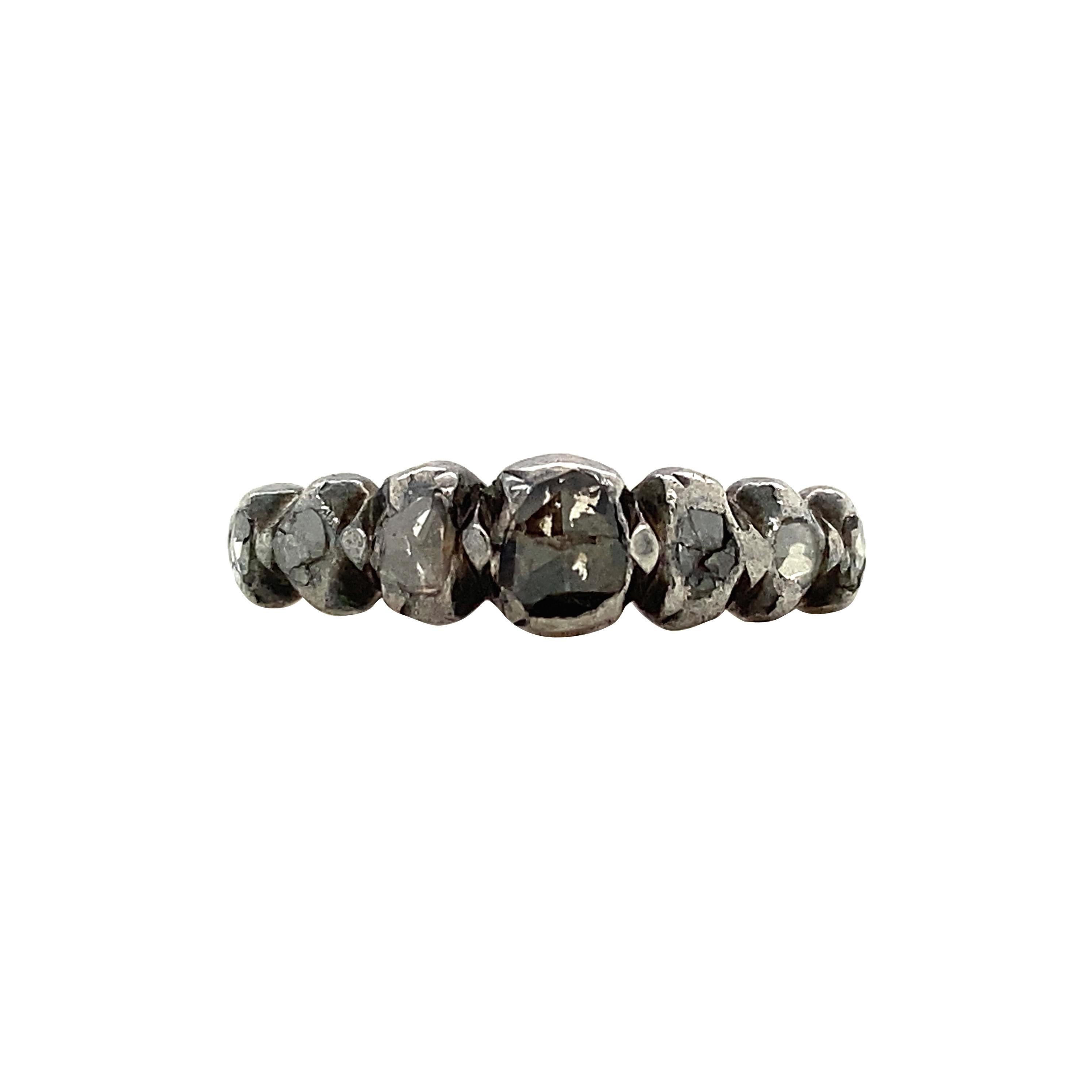 Dating to the Georgian period, this antique half-hoop ring features graduated foil-backed rose-cut diamonds set in silver atop a rose gold band. One of the most storied jewels in our collection, this ring was made between 1714 -1837 - meaning it