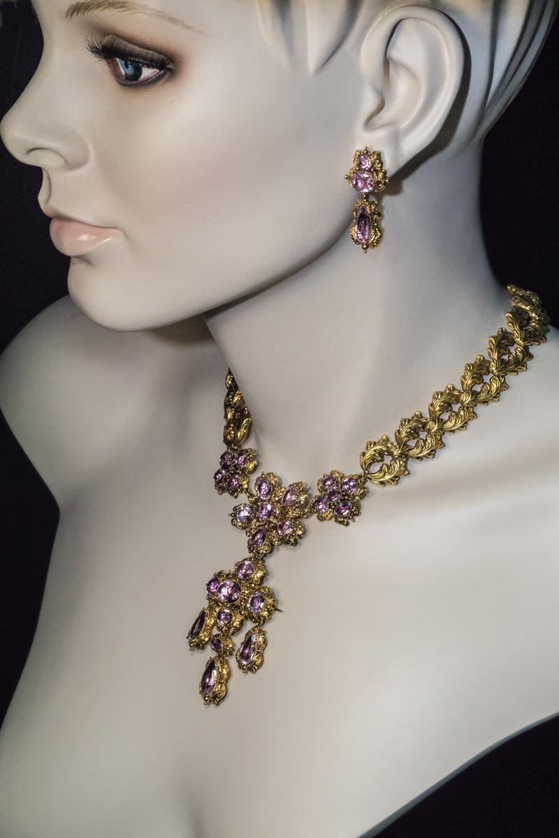 Circa 1830

This ornate antique pink topaz and 14K gold set is comprised of a superb quality necklace and a pair of earrings. The pendant can be detached and worn as a brooch.

Total length of the necklace 42 cm (16 3/4 in.)

Weight:  65