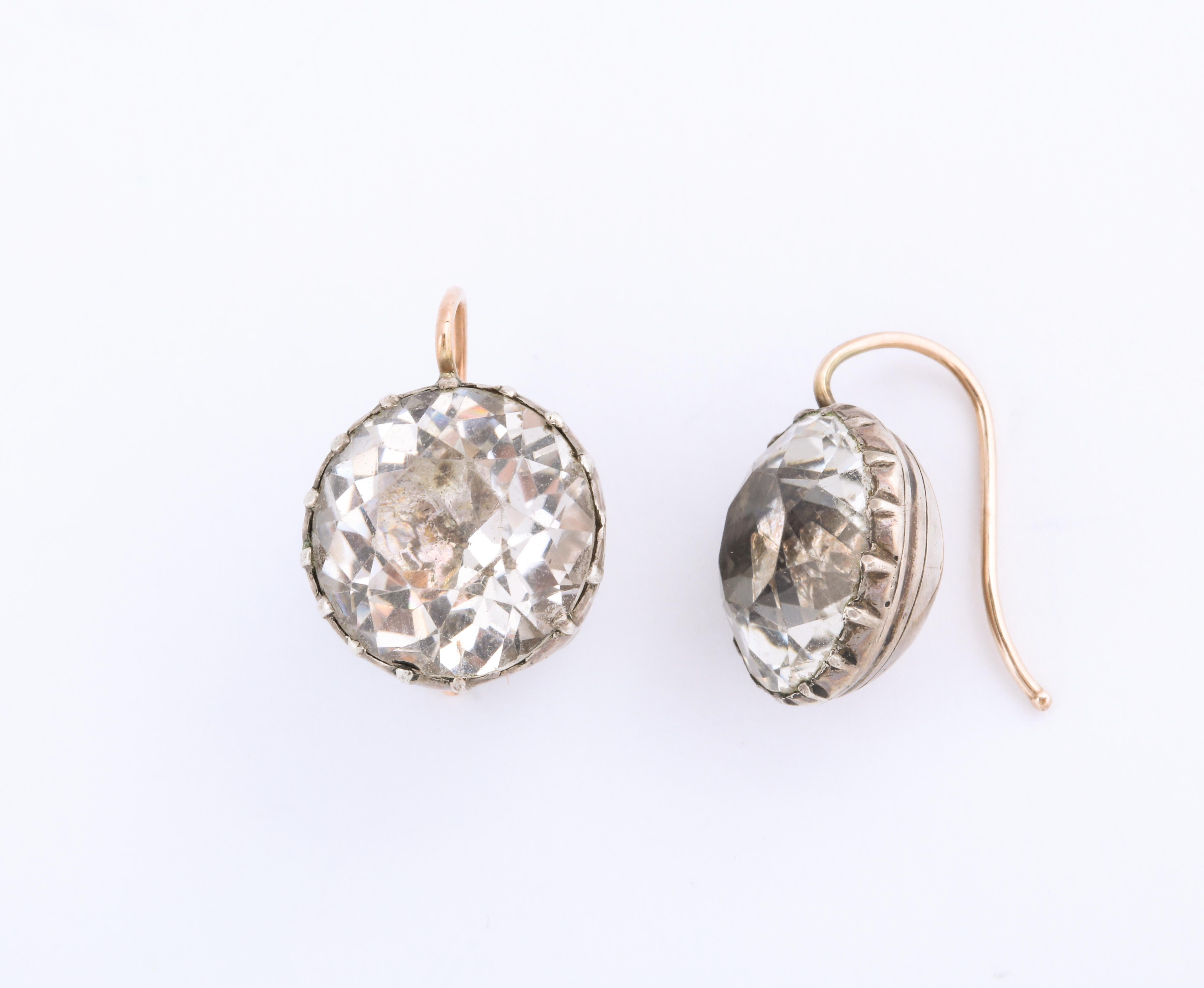 Georgian paste drop earrings of approximately 6 ct each, have become a classic to wear constantly. This lovely faceted pair are set in foiled, round, silver settings with gold ear wires. The size makes them dressy enough for evening. The clear
