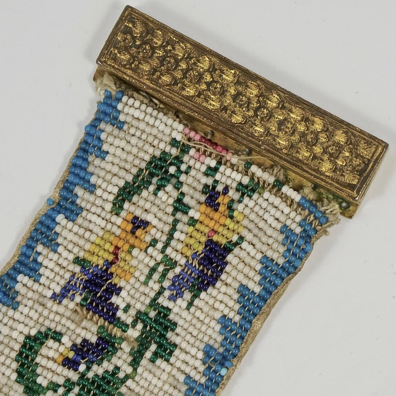 Beautiful Georgian beaded cuff bracelet with a lovely floral design edged in blue, and a decorative floral brass clasp. The beads are lined with a silk back. It is stamped JD. Measuring length 17cm / 6.7 inches by width 3.8cm / 1.5 inches. There are