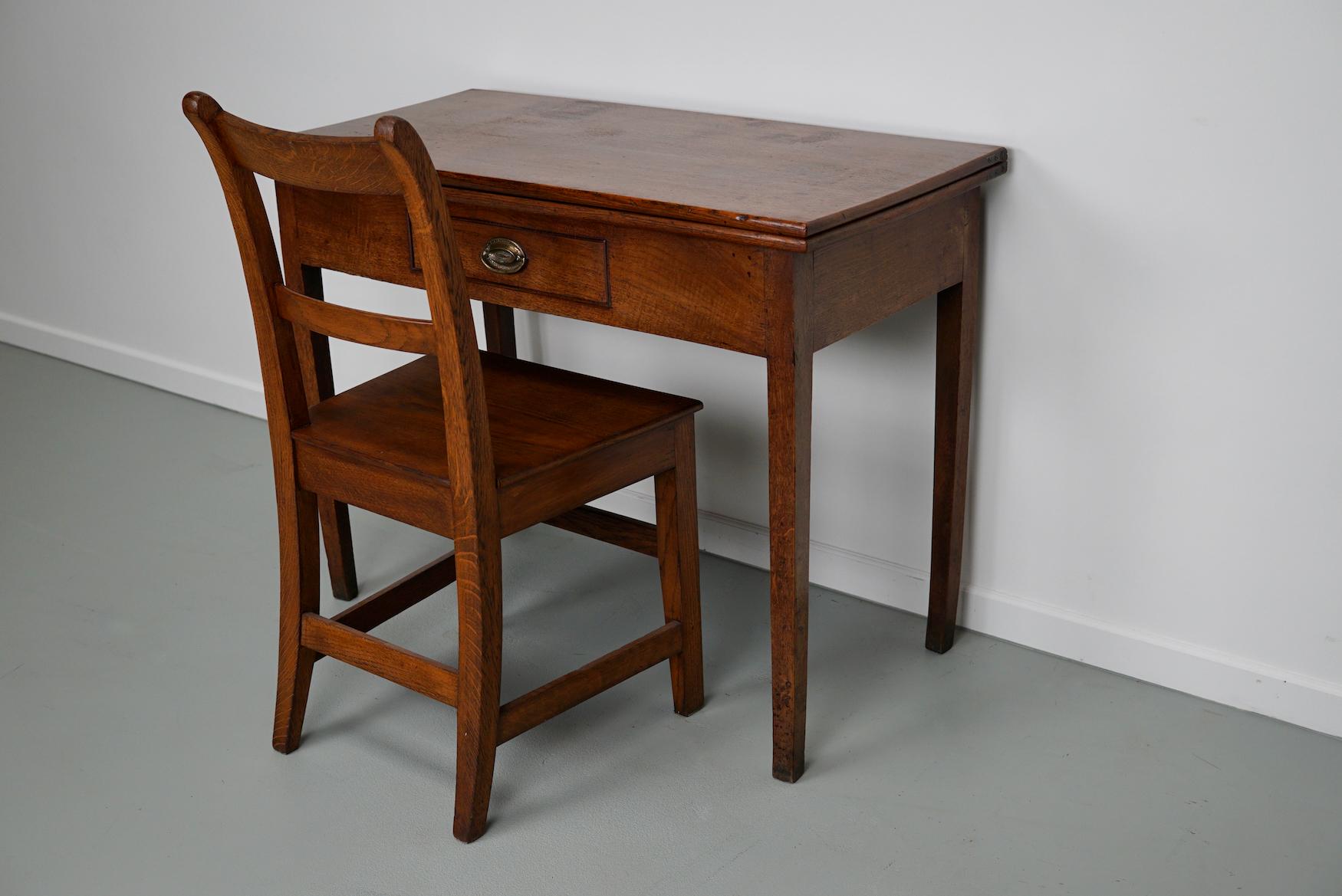 This writing table was designed and made in England around 1800. It can be folded into a large square table. It comes with a nice antique oak chair that has the same color / finish.