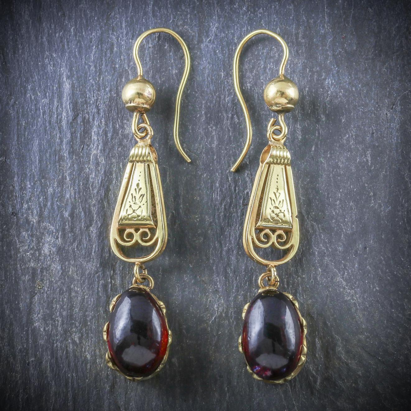 A pair of fabulous antique Cabochon Garnet drop earrings that are from the Georgian era, Circa 1800

Each earring displays a beautiful deep red cabochon Garnet which are 4ct each

One of the Garnet’s has a small hair line fault but this is minimal