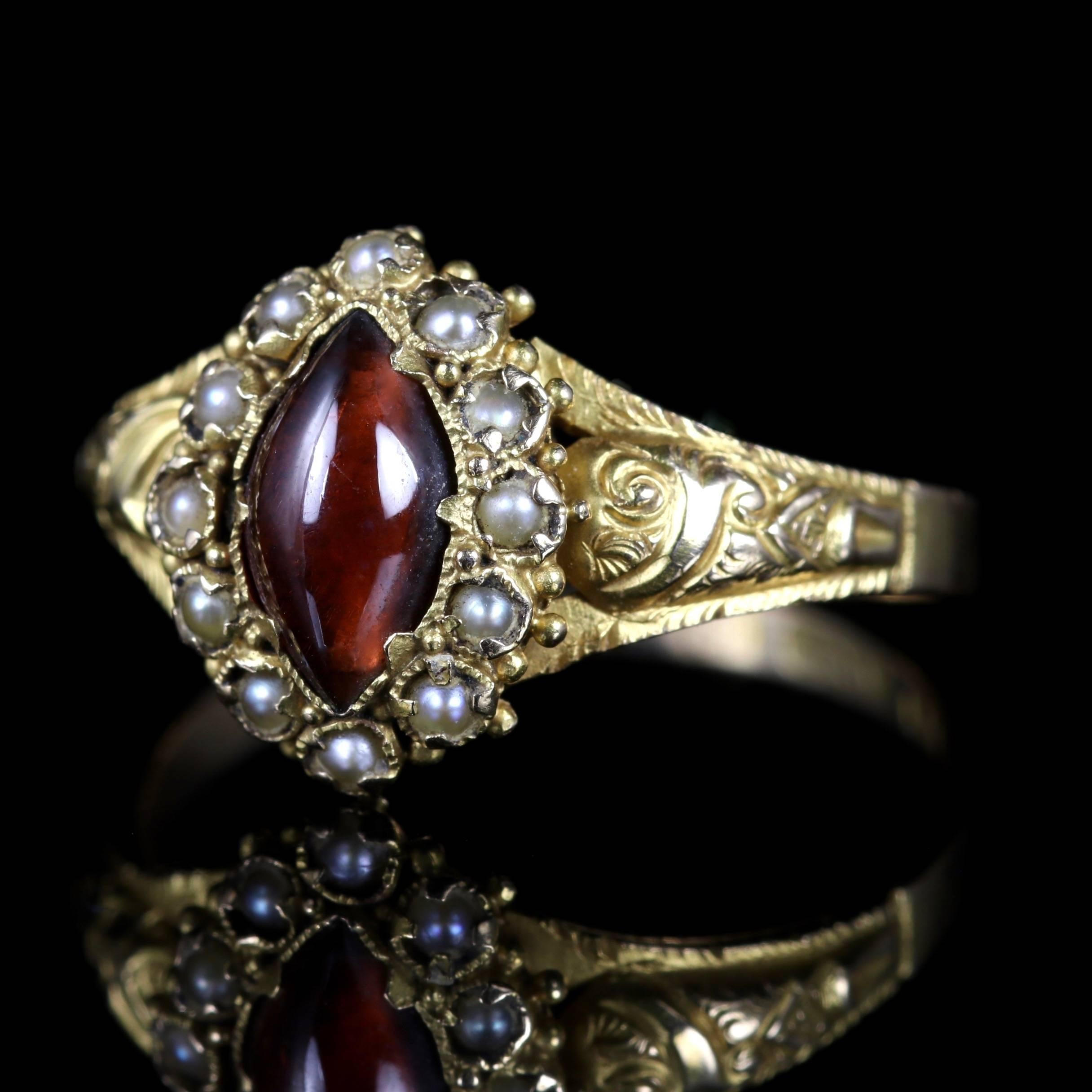 This fabulous Georgian Cabochon Marquise cut Garnet is set in 18ct Gold, Circa 1820.

The ring is adorned with a halo of Pearls in a beautiful engraved Georgian gallery.

Due to its age, Georgian jewellery is quite rare, with some pieces almost