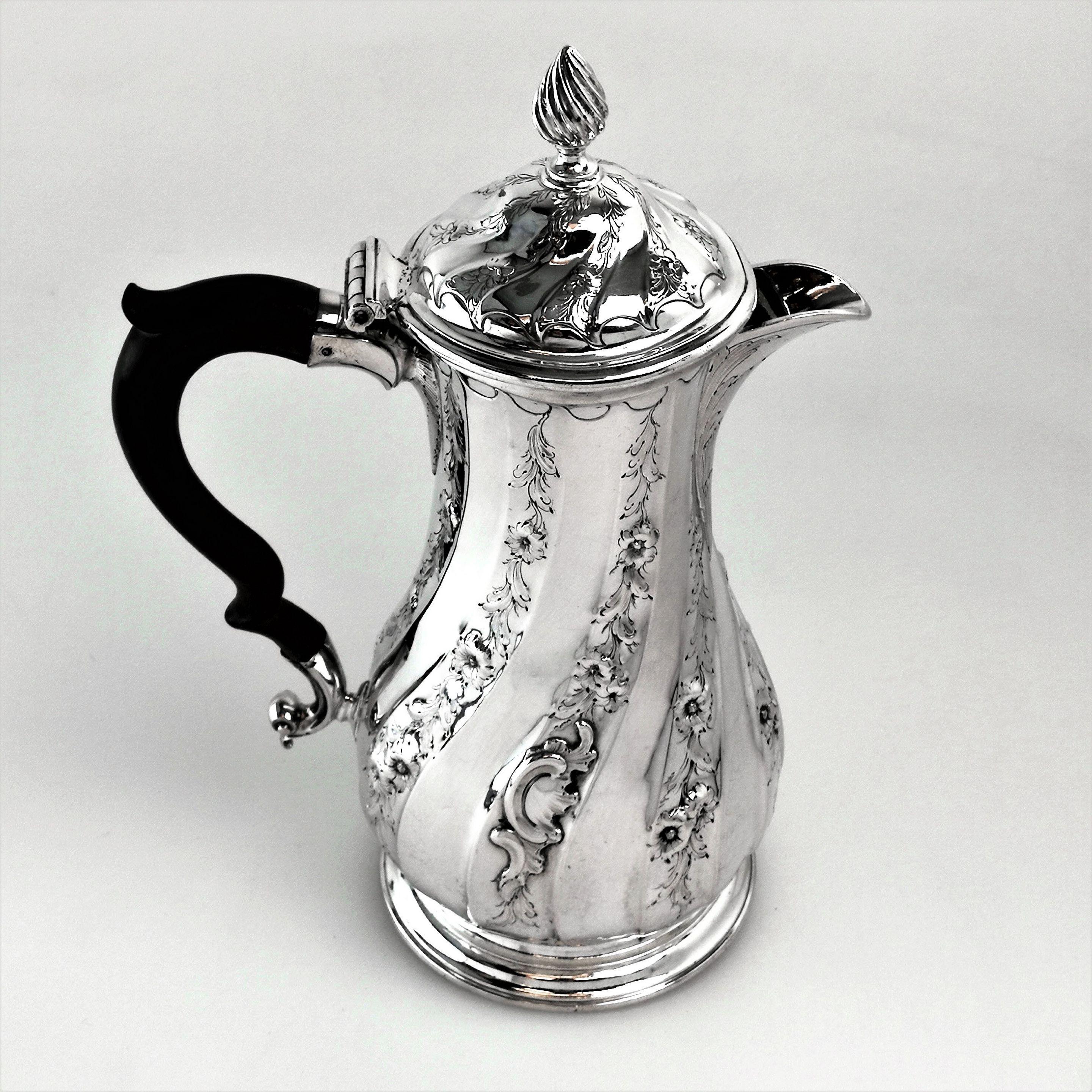 An excellent George II Georgian sterling Silver Coffee Pot / Hot Water Jug in a unusual Rococo design. This Coffee Pot boasts some wonderful design elements including an unusual asymmetrical spout and shaped rim to the Pot and fitted lid. The rhythm