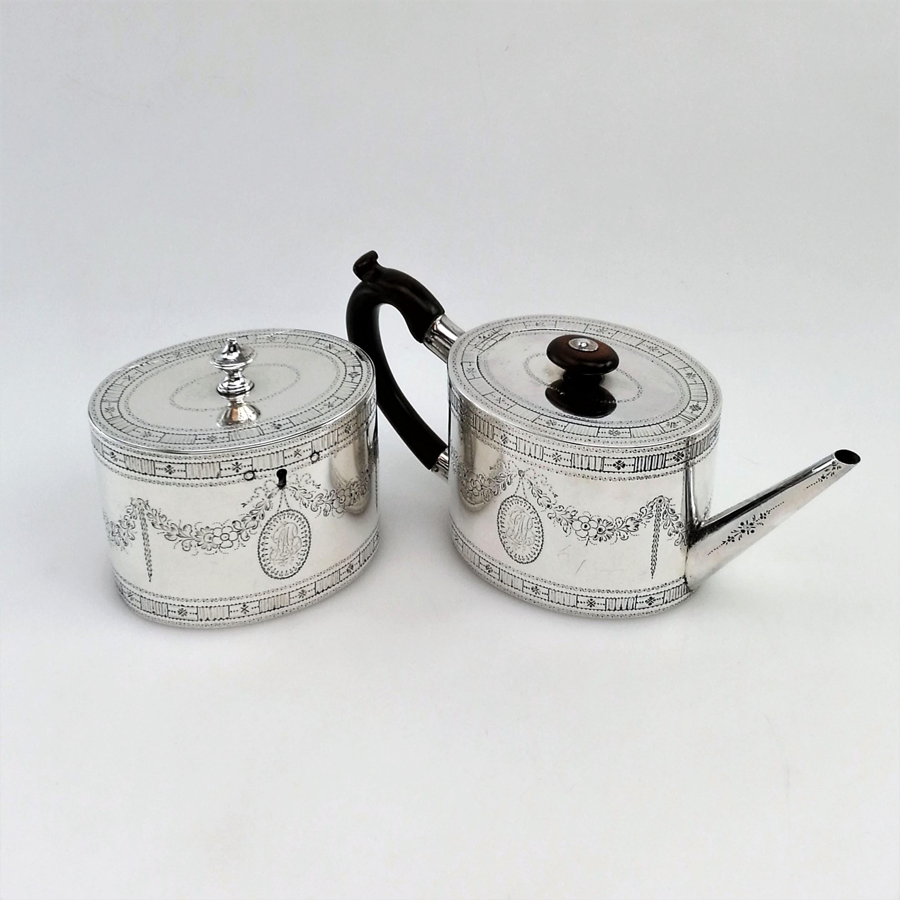 A wonderful matched Antique George III Sterling Silver Teapot & Tea Caddy Set. Each piece is in a classic oval can shape and each is embellished with an ornate border on both top & bottom rims of the body and around the rims of the lid. The bodies