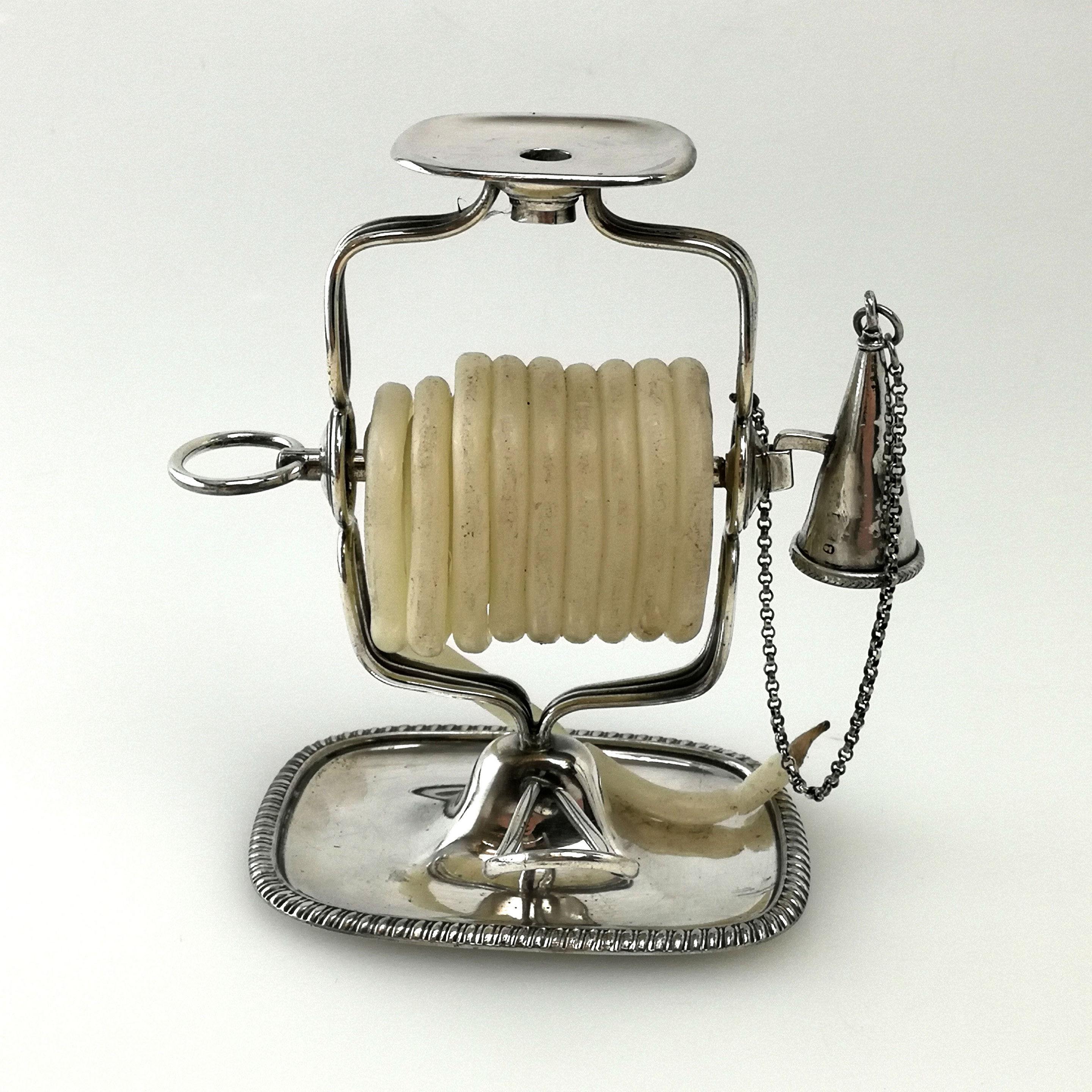 A lovely antique Georgian solid silver wax jack with a rounded corner rectangular base with a gadroon border. The wax jack has a small conical snuffer on a chain and has a roll of white wax.
 
 Made in Sheffield in 1805 by William Tucker, James