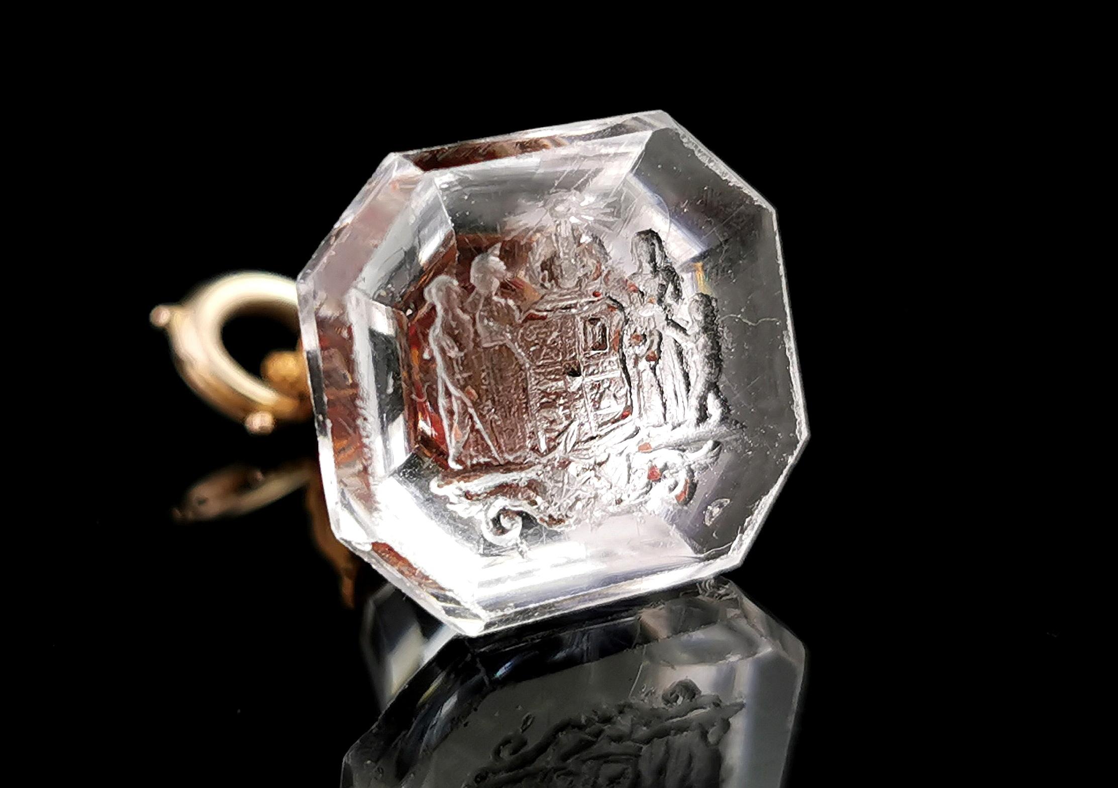 An incredible and rare antique Georgian era seal fob.

Late 18th century, this magical seal fob is made up of a carved clear glass intaglio with a fluted shape, the base carved with an elaborate design.

It features a number of people including a