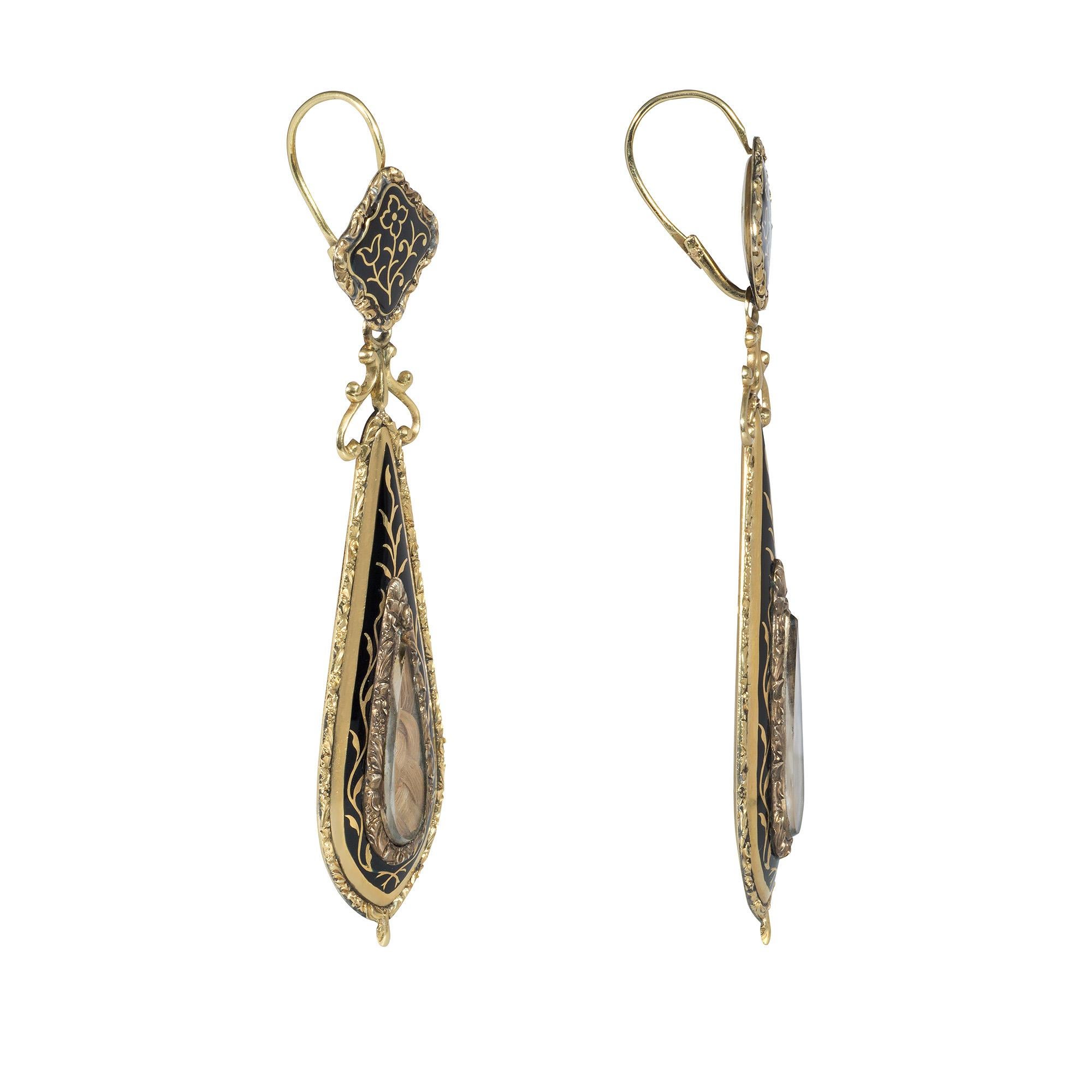 A pair of antique Georgian period black enamel and gold day-to-night mourning earrings comprised of removable drop-shaped pendants of foliate design with a plaited hair inset under crystal and scrolled surmounts, suspended from diamond-shaped floral