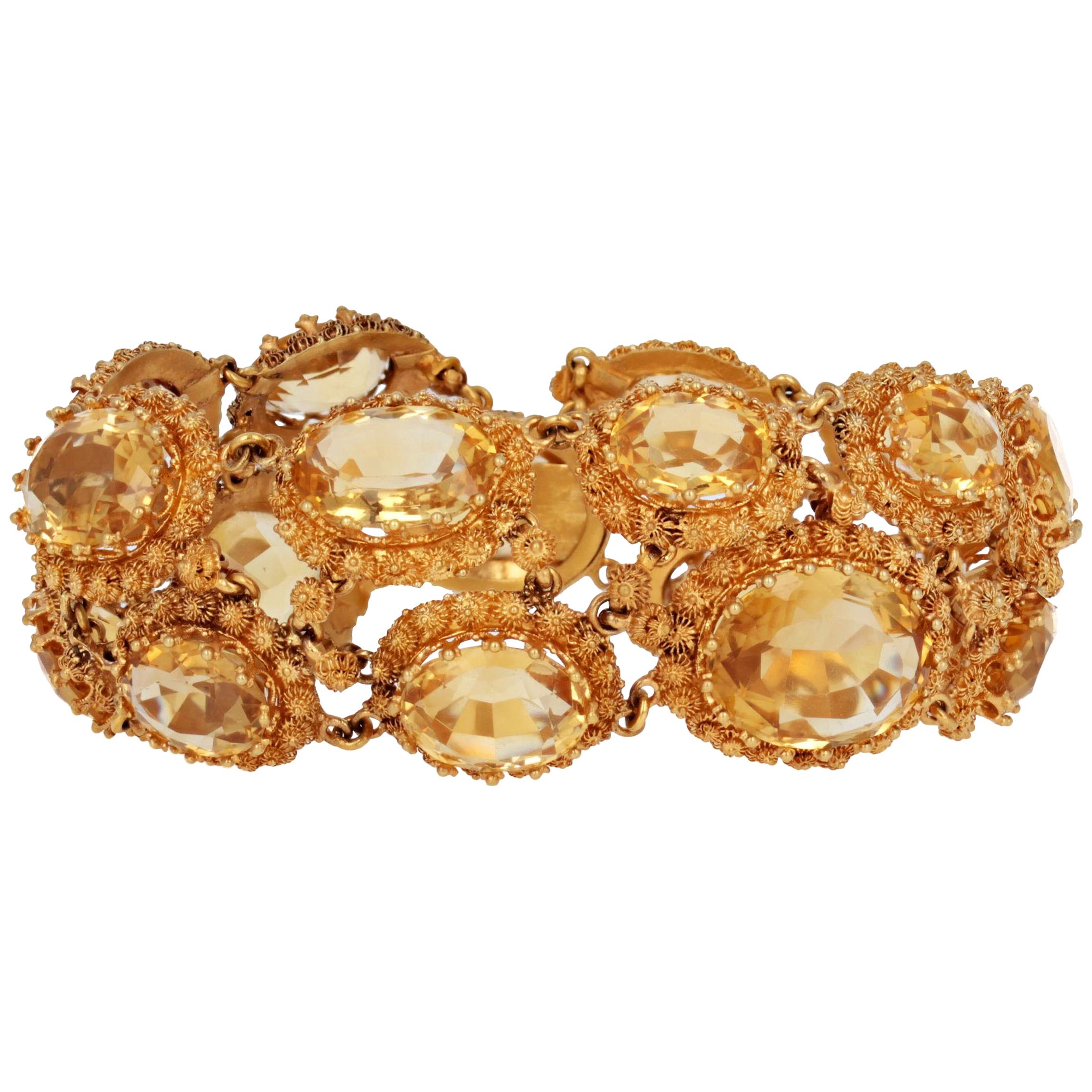 This stunning antique Georgian bracelet features a double row of eighteen oval citrines with a total approximate weight of 60 carats. Each citrine is set within a starburst motif frame and mounted in 18 karat yellow gold. It was made circa 1820 and