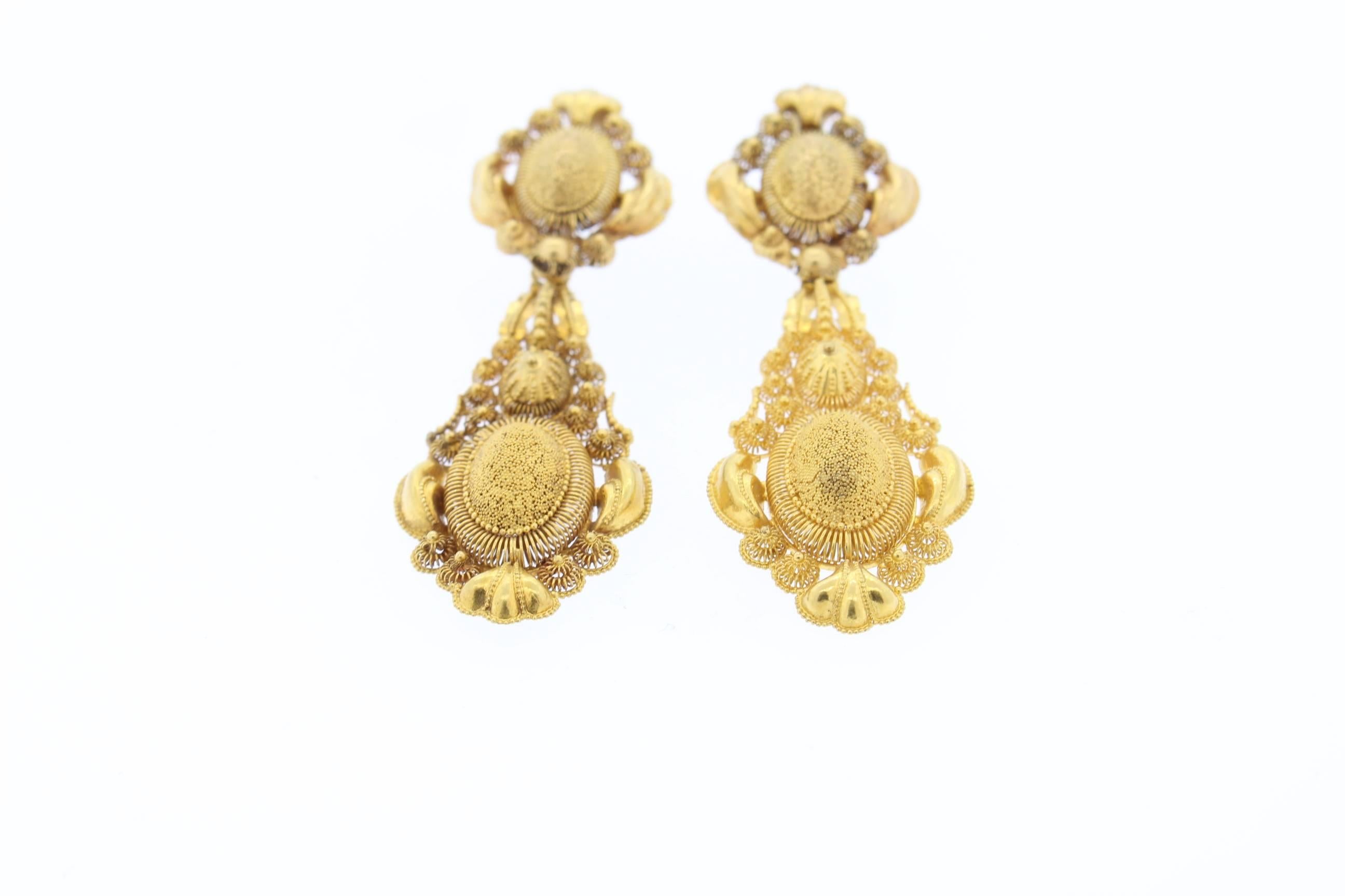 These antique earrings are light and delicate yet have presence and size when worn.  The earrings are made of 18k gold and have exquisite cannetille work from about 1820.  Cannetille work was a favored style in the 1820s and 1830s where wirework and