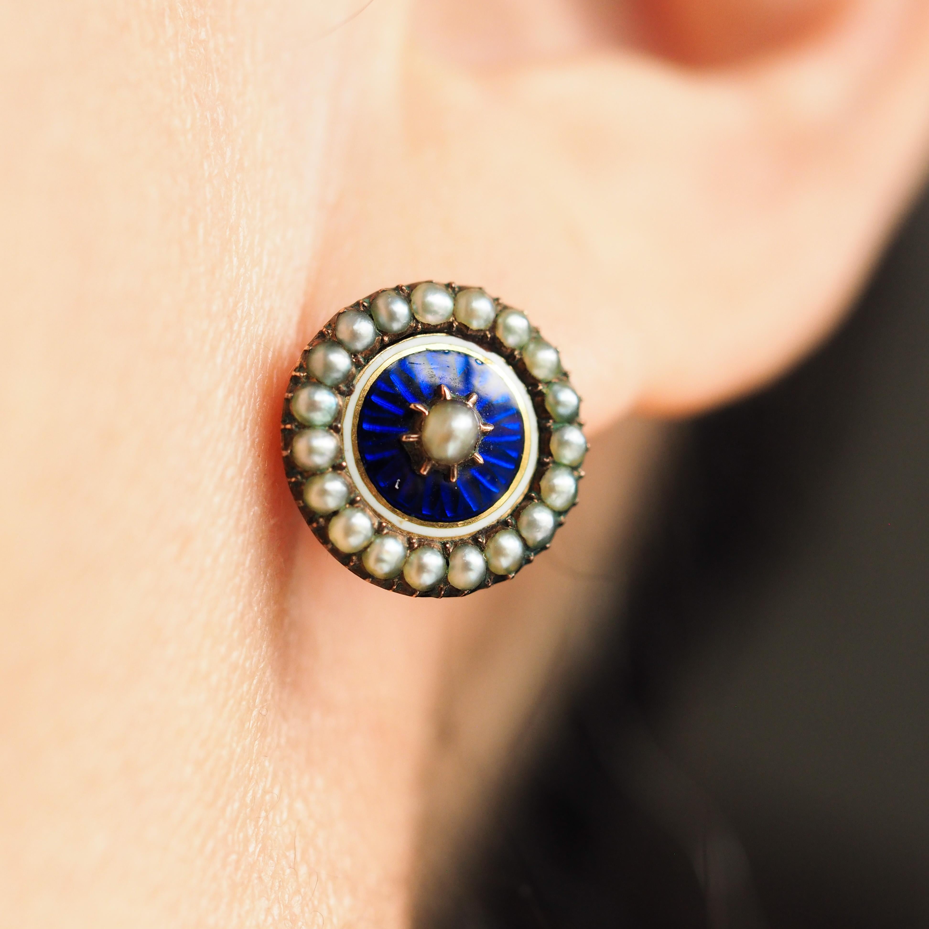 We are delighted to offer this magnificent pair of antique Georgian gold enamel earrings, made c.1880.
  
This unique and beautiful pair is made with the most captivating royal blue enamel on top of a sunburst guilloche design. The surrounding seed