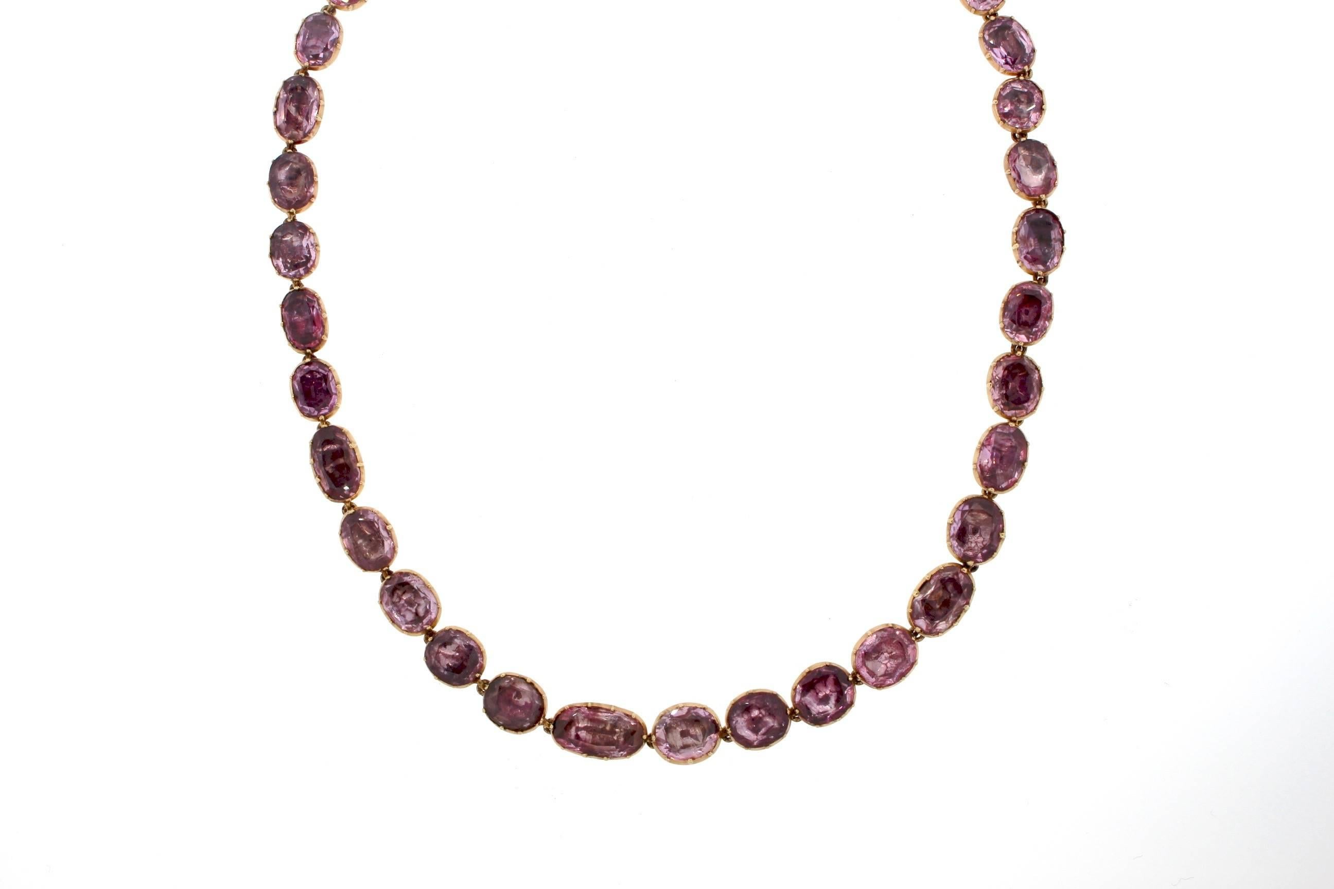 Georgian pink topaz foil backed riviere necklaces are becoming more and more rare.  The pretty light pink to slightly purple color are enhanced by the closed back setting characteristic of Georgian jewelry craftsmanship.  The foil behind the stones
