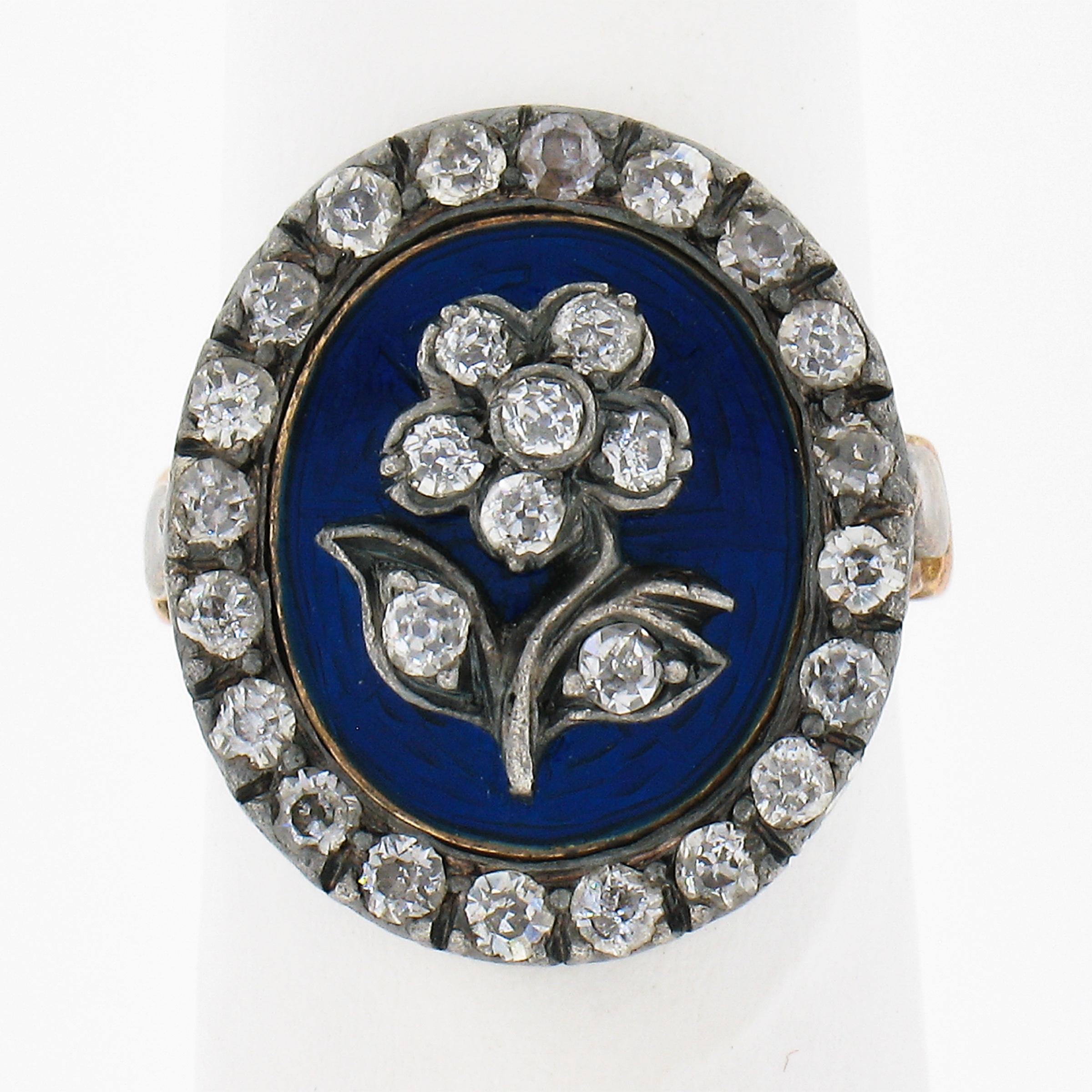 This gorgeous antique diamond ring is crafted during the late Georgian era in solid rosy yellow gold with silver top and and features a beautiful diamond flower at the center of the oval design that is beautifully adorned with royal blue enamel
