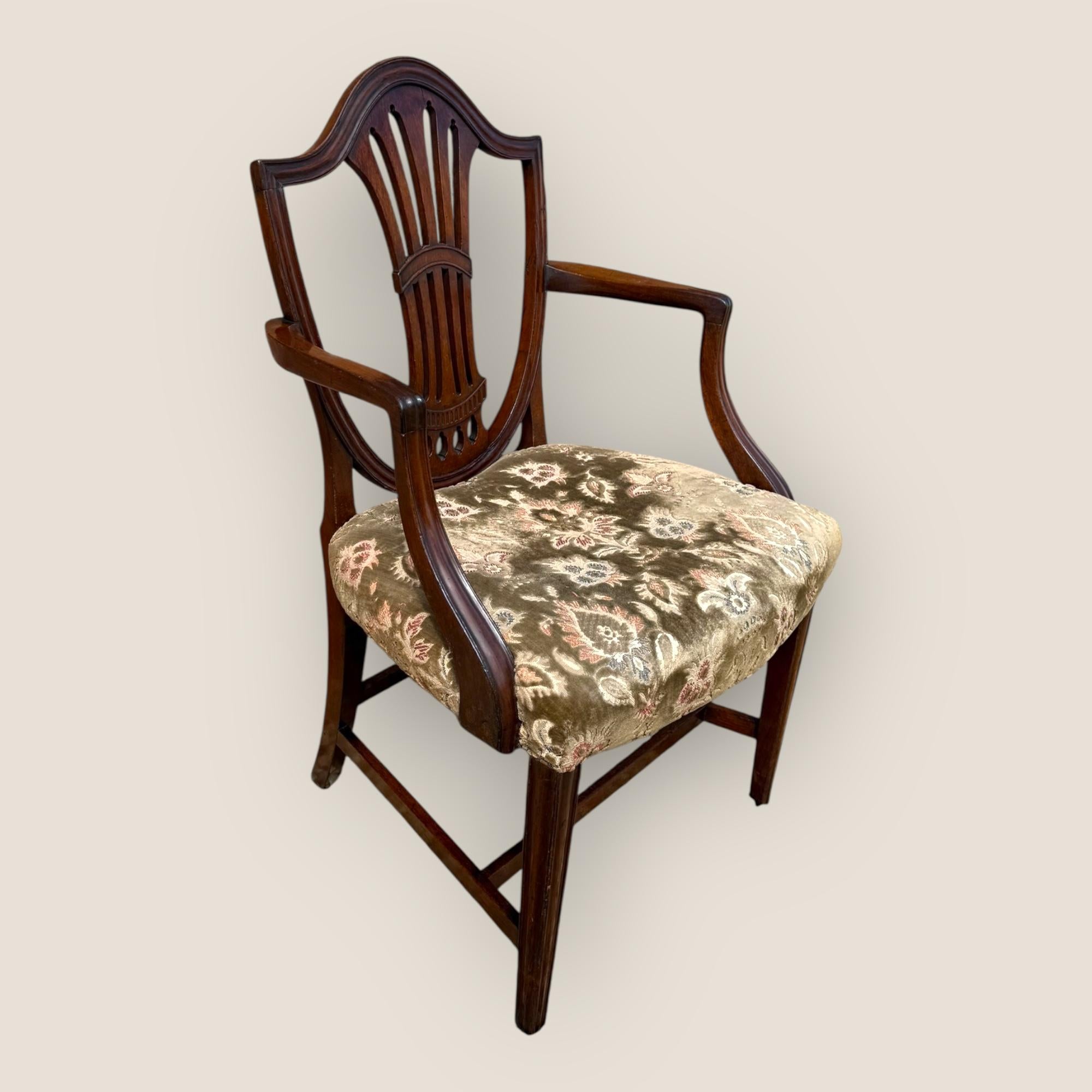 Here we have a Georgian Hepplewhite period, circa 1785, shield back Mahogany Carver Chair, with a green and floral fabric seat. The seat itself has some of the green colour fading but everything else with this chair is good condition.