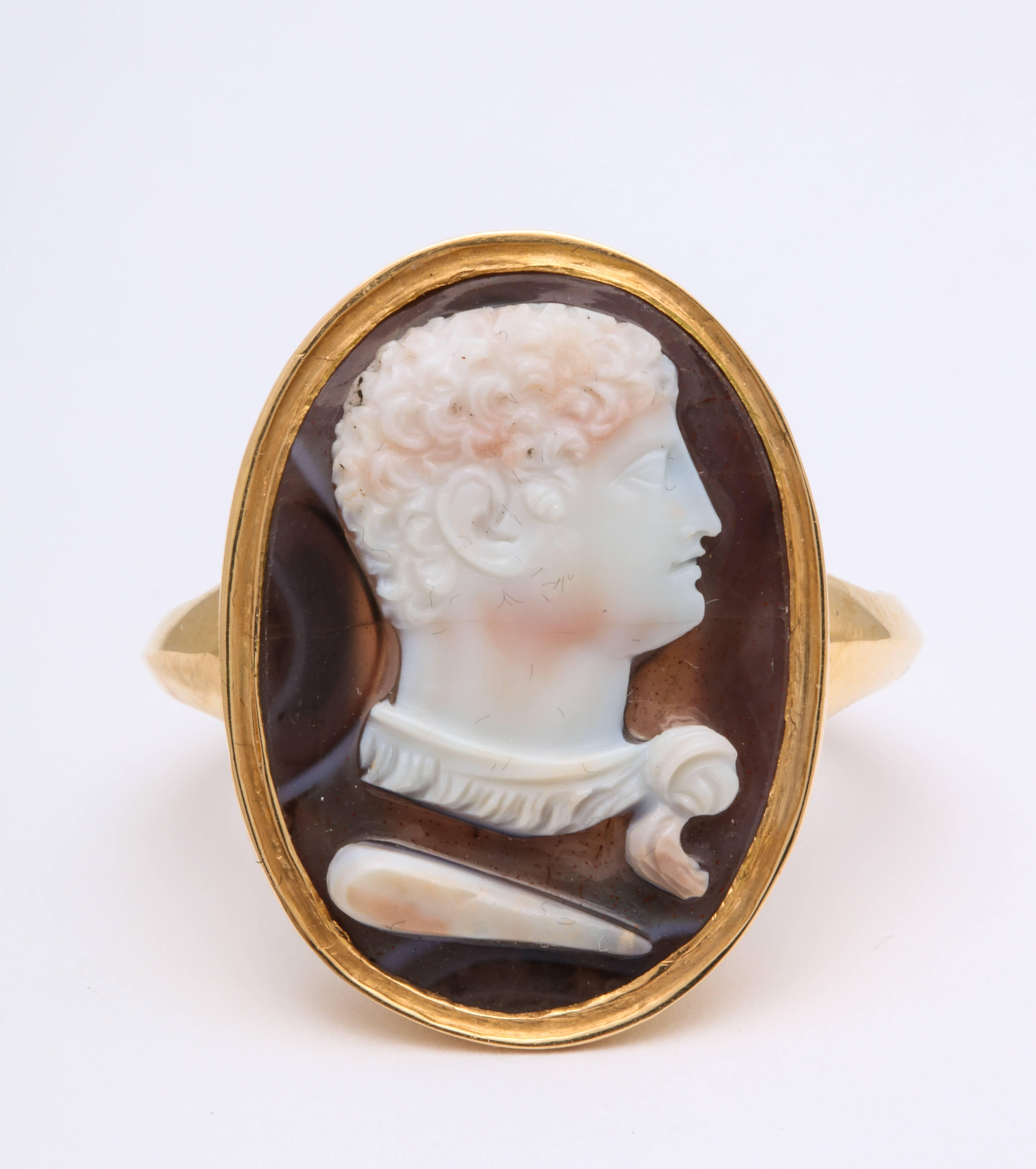 Everything about this ring speaks of power, as Hercules, famed for his strength, appears in f carved in three strata on this 18 kt hard stone cameo ring c. 1820. The hero appears in with his attributes of a club and lion pelt that he wears wrapped
