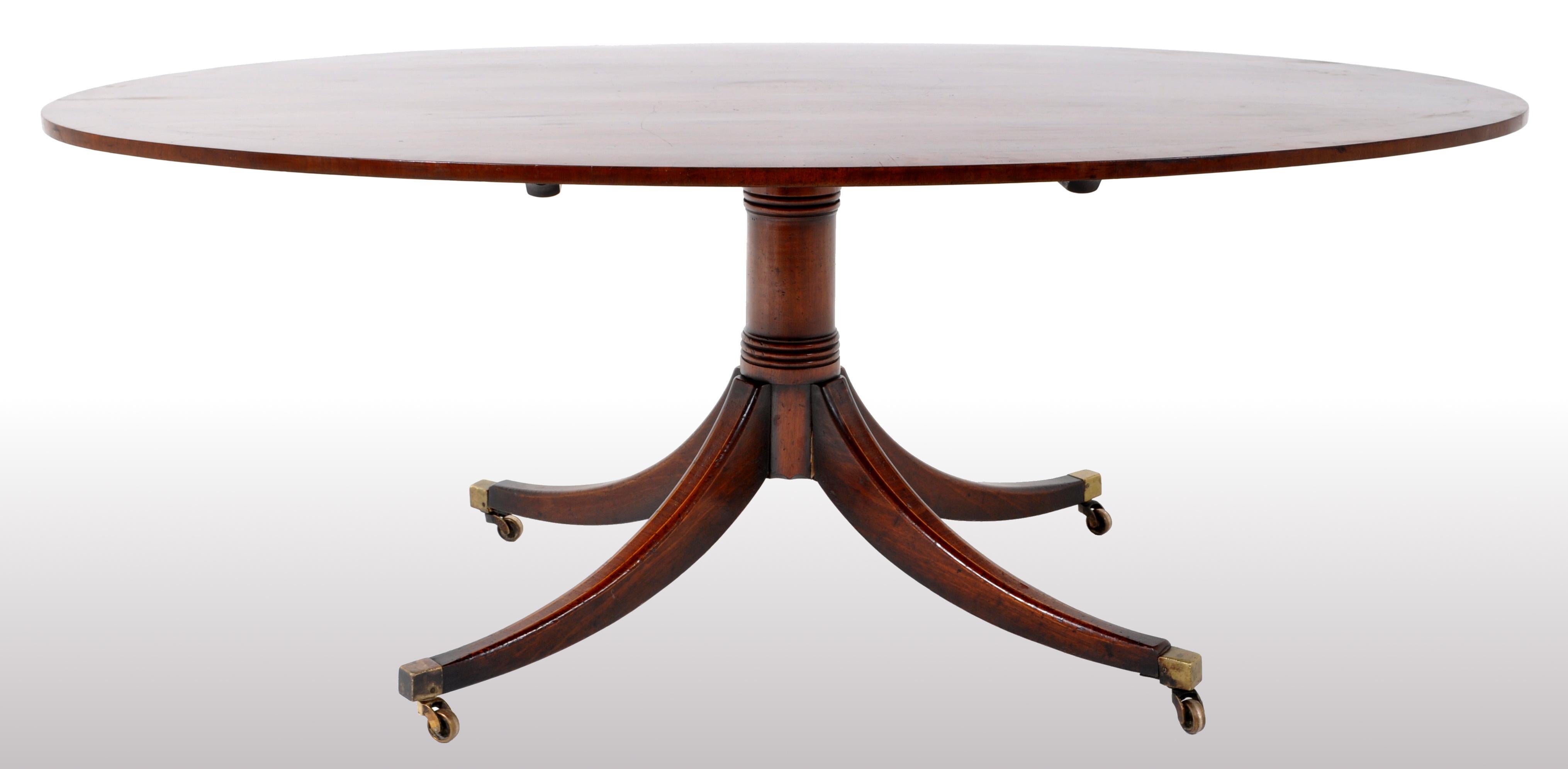 A fine and large George III tilt-top mahogany dining/breakfast table circa 1790. The table made of the finest solid Cuban flame mahogany and made of a single board, the top of oval form inlaid & crossbanded to the edge and having an oval paterae