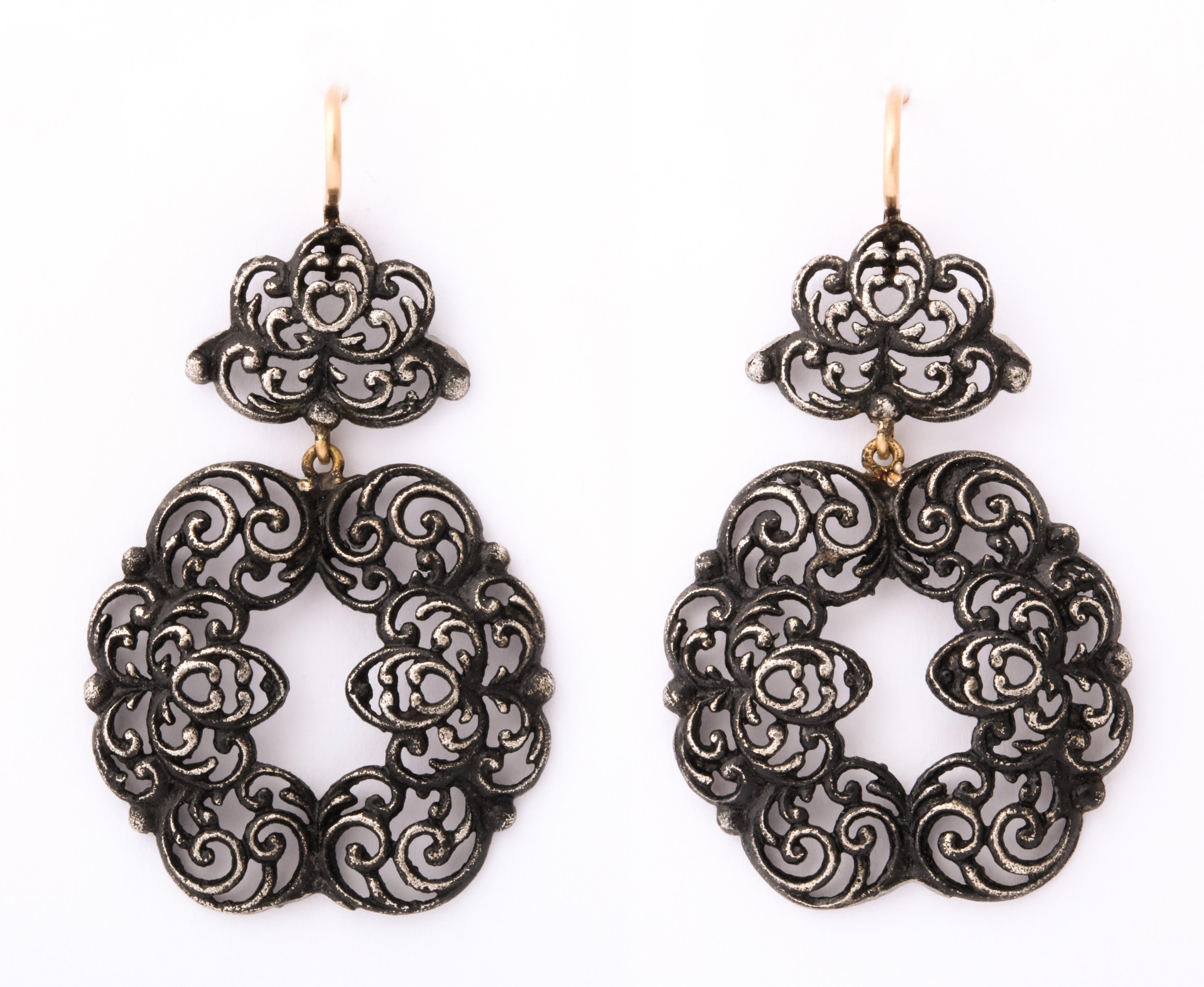 A pair of Berlin Iron Earrings that are feather weight and look like fine lace swirls. The earrings have a gold ear wire were made from a Geiss necklace that e to c.1820. During the Napoleonic wars, Germany asked their citizens to turn in their gold