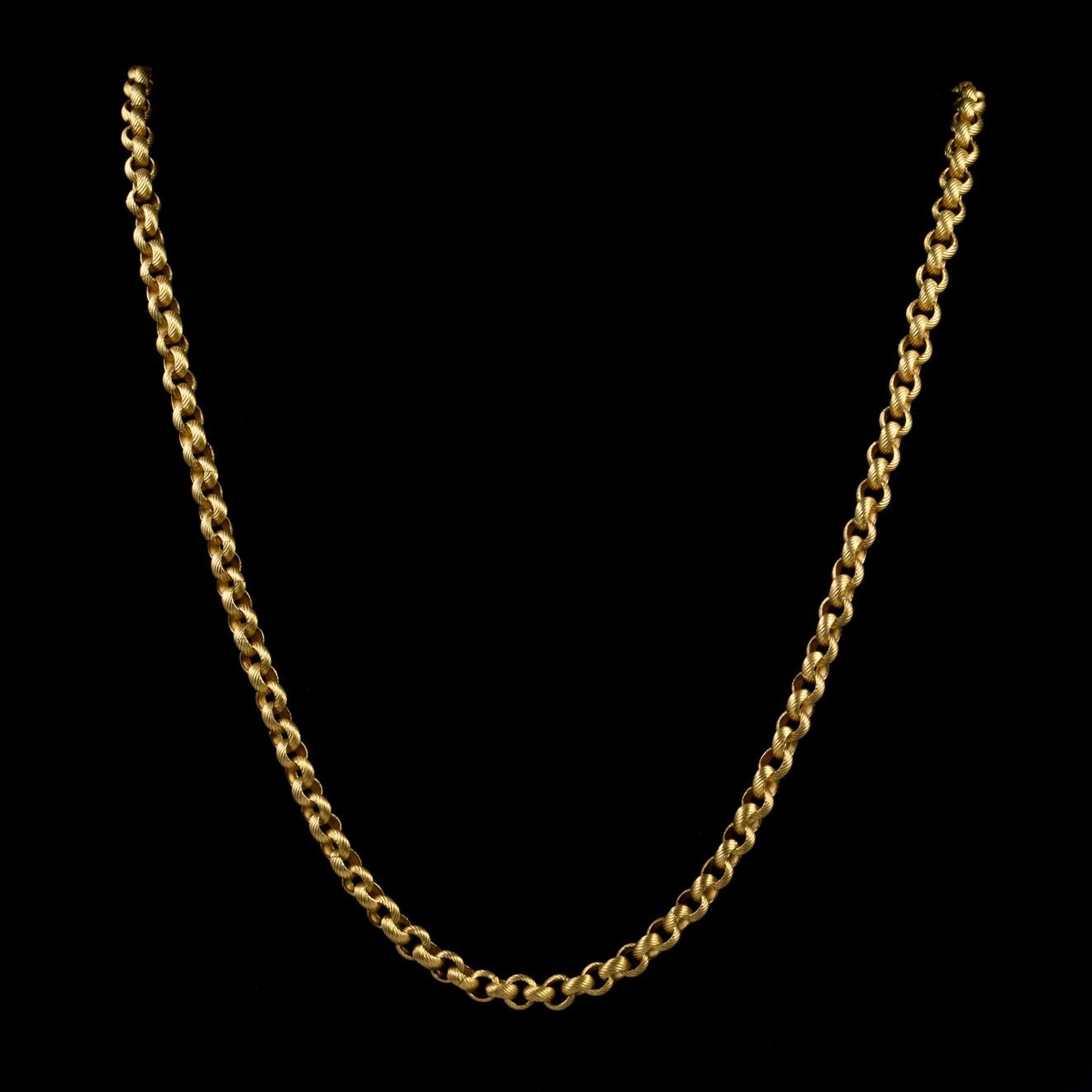 This exquisite long antique guard chain has been beautifully preserved from the Georgian era. The piece is made up of textured links crafted in Silver and gilded in 18ct Yellow Gold. 

The barrel clasp is very striking and has been expertly engraved