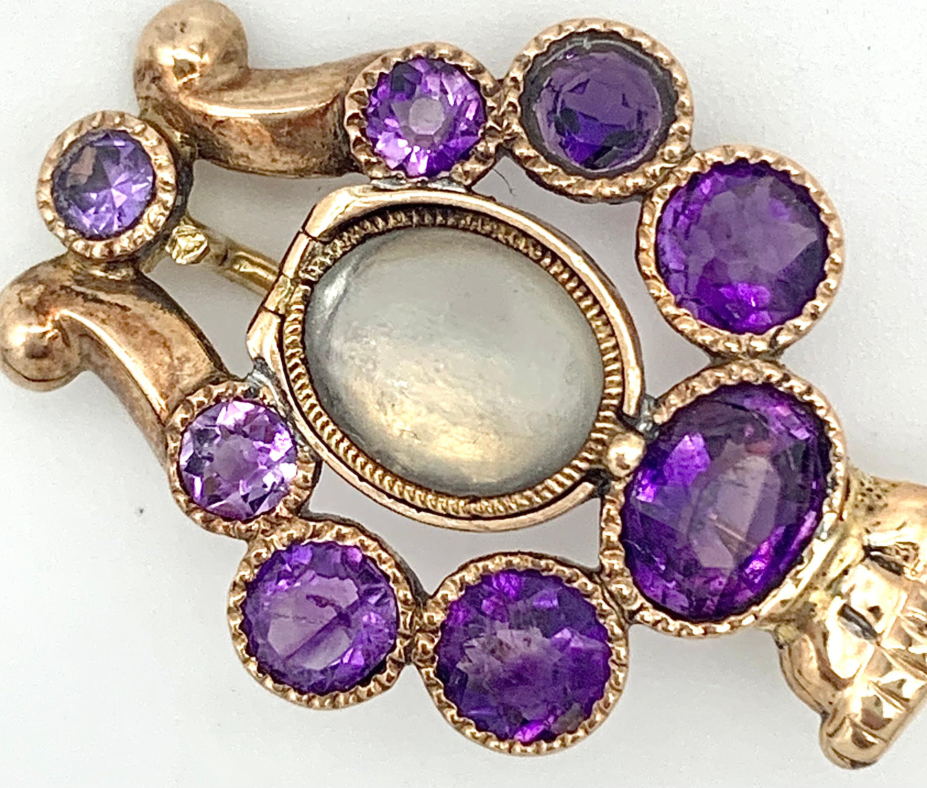 This wonderful Georgian gold lyre brooch is set with amethysts and has a little locket with a hinged lid.
The lyre is the instrument of Apollo. In Greek and Roman Mythology Apollo is the god of light, spring, song and music   
