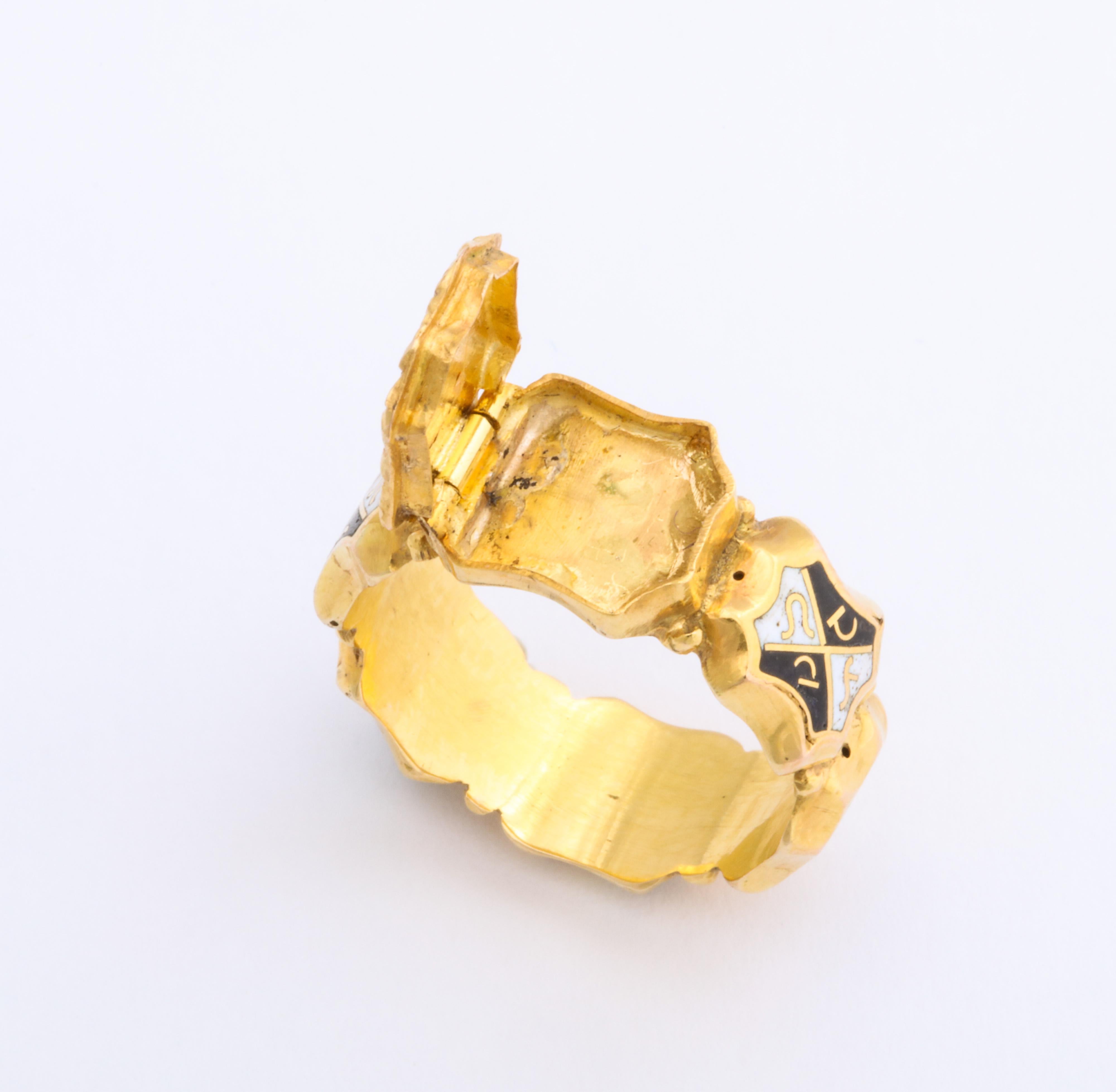 An extraordinarily scarce ring with six harlequin panels of 18 Kt gold magical writing wrap your finger in historic mystery and center it with a locket that opens and that held who knows what back in the early 1800's. The writing changes with each