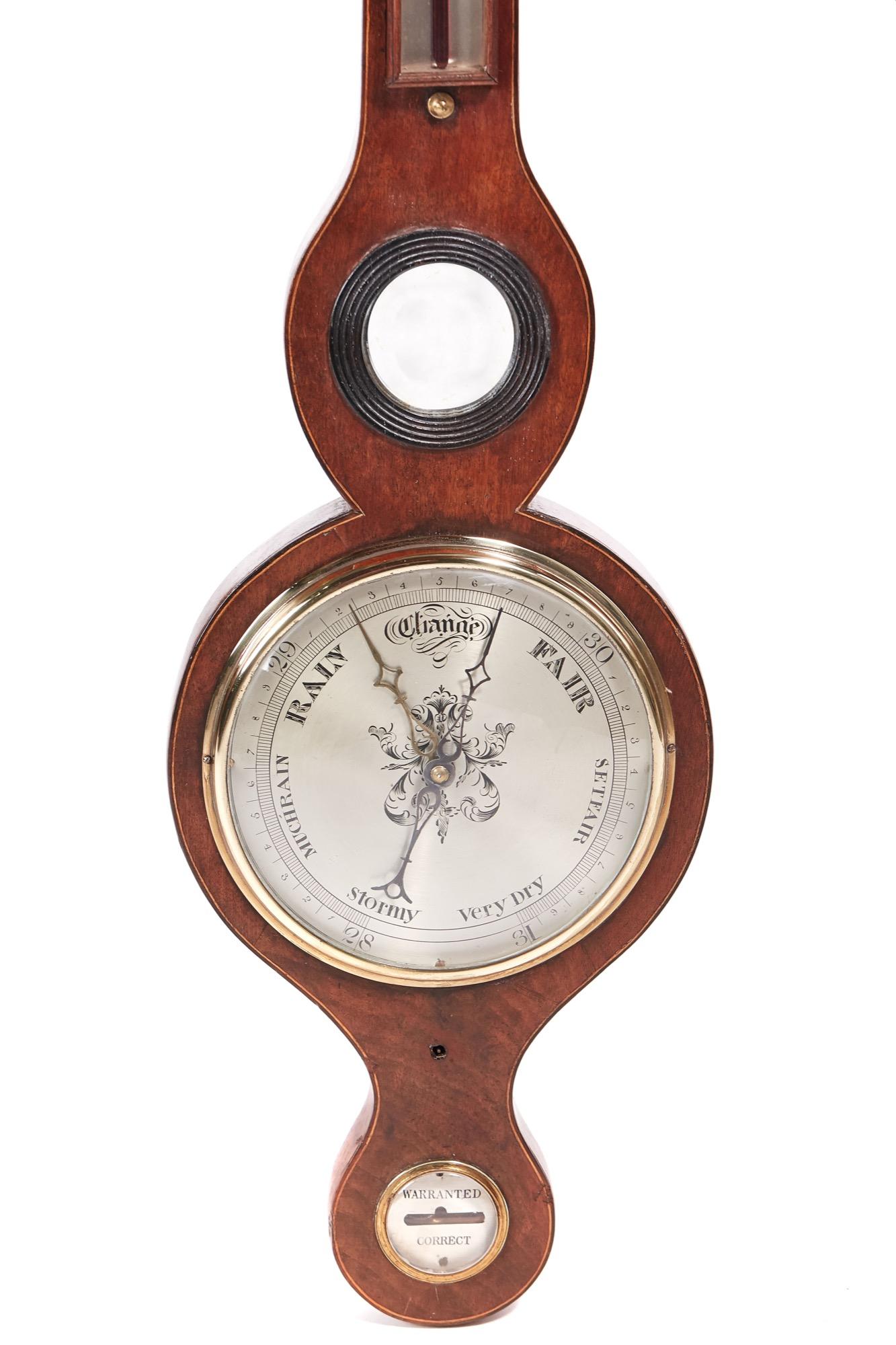 Antique Georgian mahogany banjo barometer having a swan neck pediment and satinwood stringing to the case, thermometer, small round mirror and a silver nine inch dial.
 