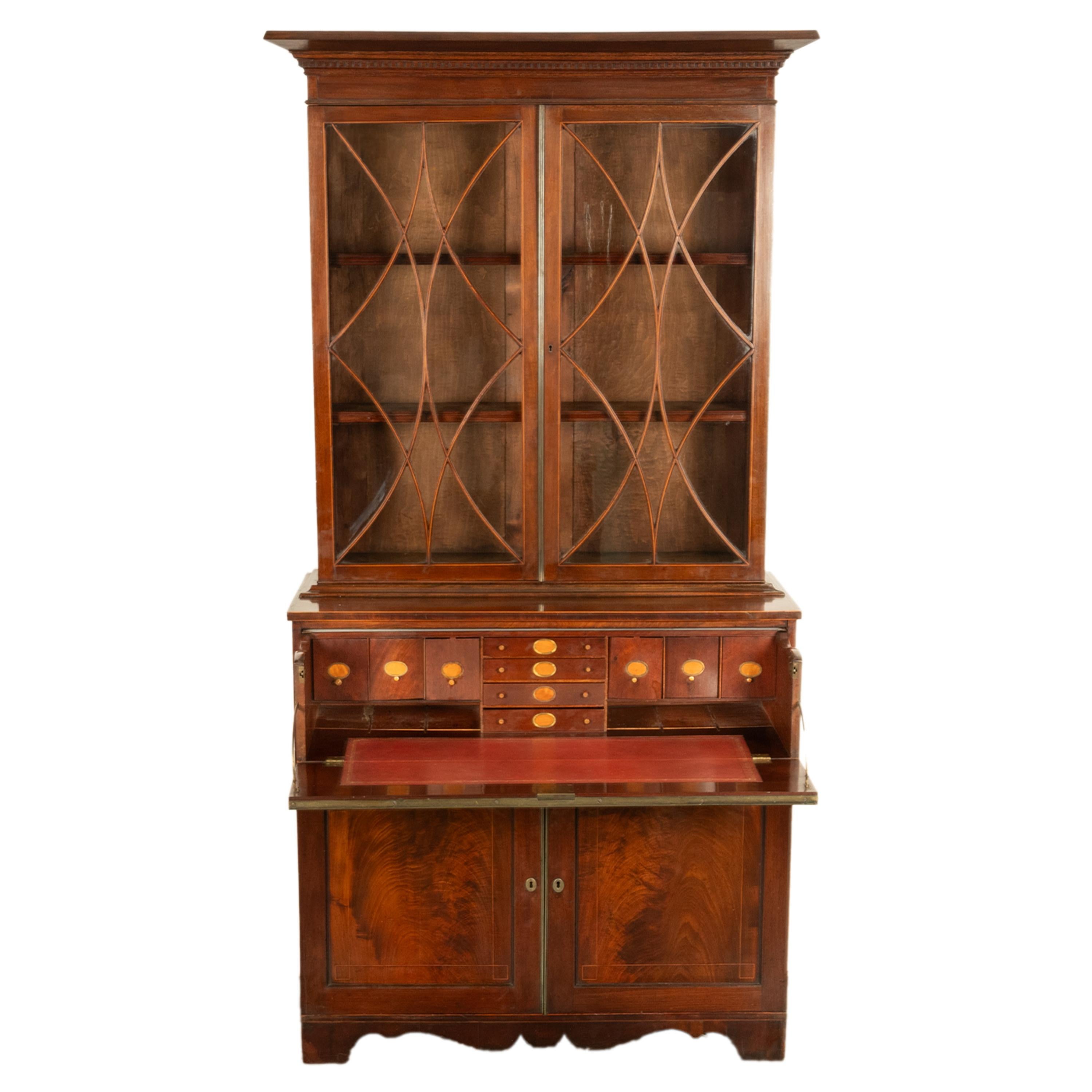 A very rare antique George III English Mahogany secretary bookcase, with a fitted collector's or doctor's cabinet to the base, circa 1790.
The bookcase in two sections; the top section with a flared cornice with a frieze of dentil molding below, the