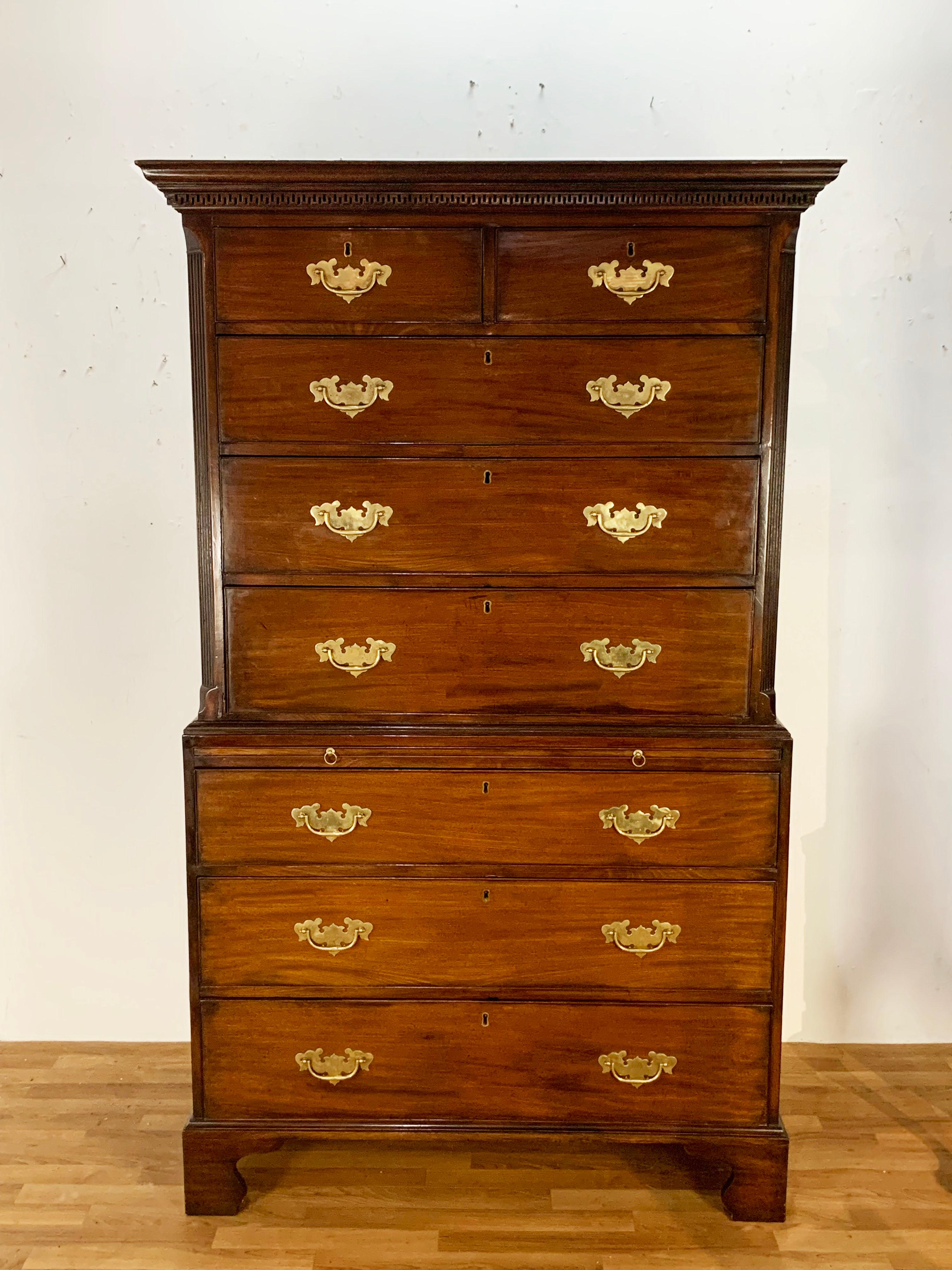 Georgian mahogany chest on chest (at left) of two over three, over three on bracket feet features English oak drawer linings, a dressing slide and generously sized batwing brasses, ca. 1780-90. The top displays a banding of finely cut dentil