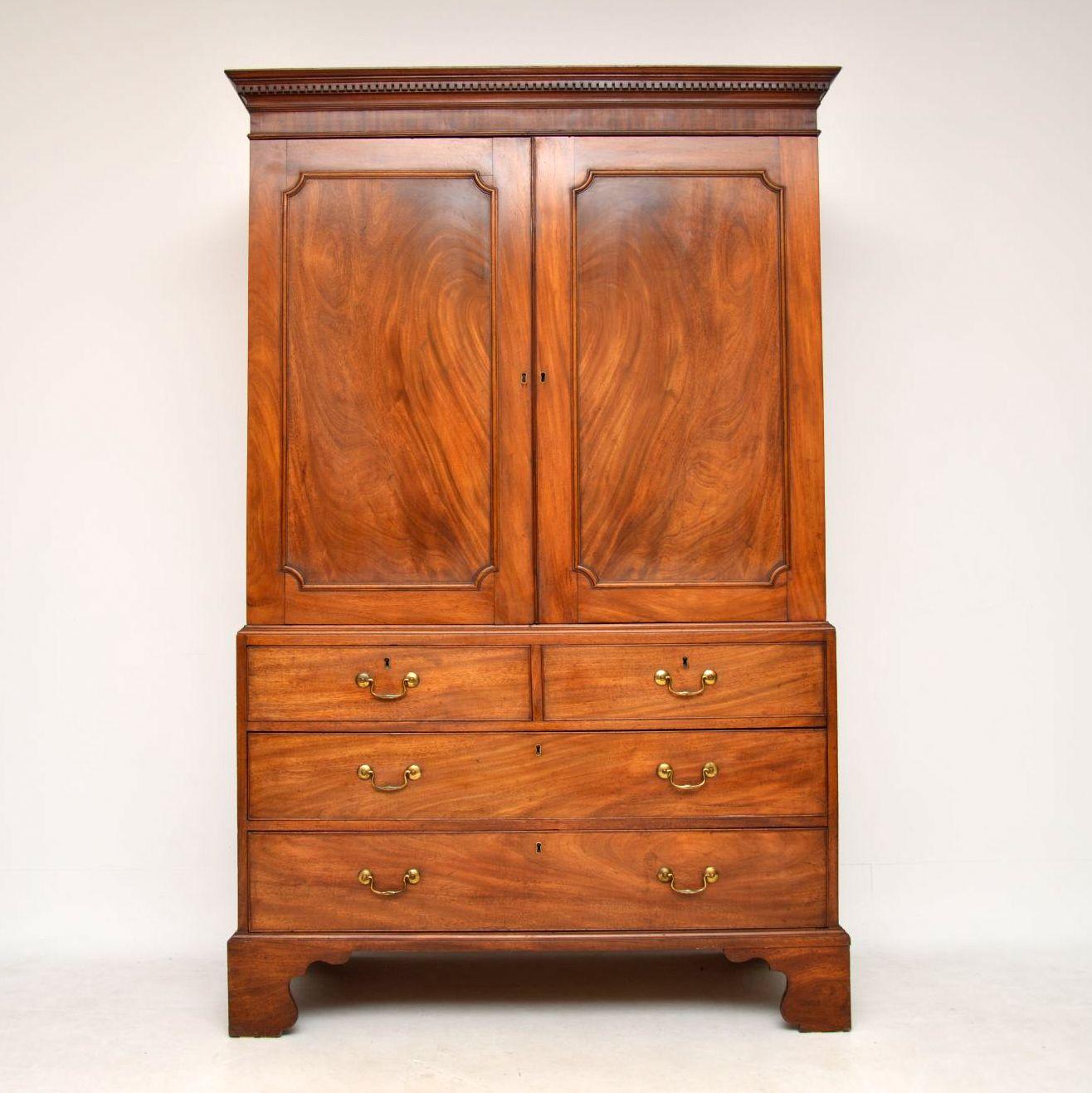 Antique George III mahogany linen press in really good original condition and dating from around the 1790 period or even a bit earlier. It has a lovely color and wonderful figuring in the wood, especially in the door panels which are solid mahogany.