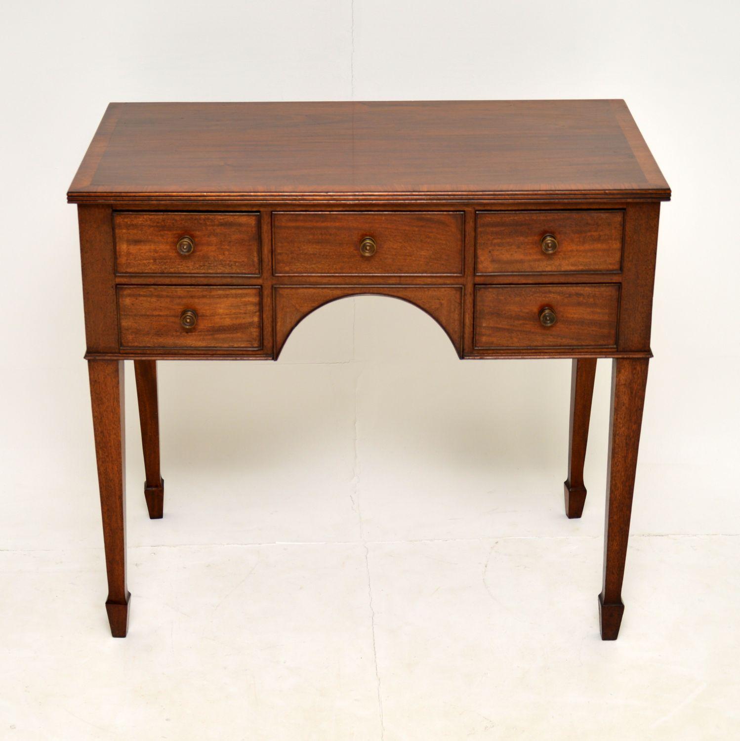 A smart and useful antique George III period lowboy in mahogany. This dates from around the 1790’s period.

It is of extremely fine quality, made from solid mahogany and is a useful size. There are lovely original brass handles, tapered legs with