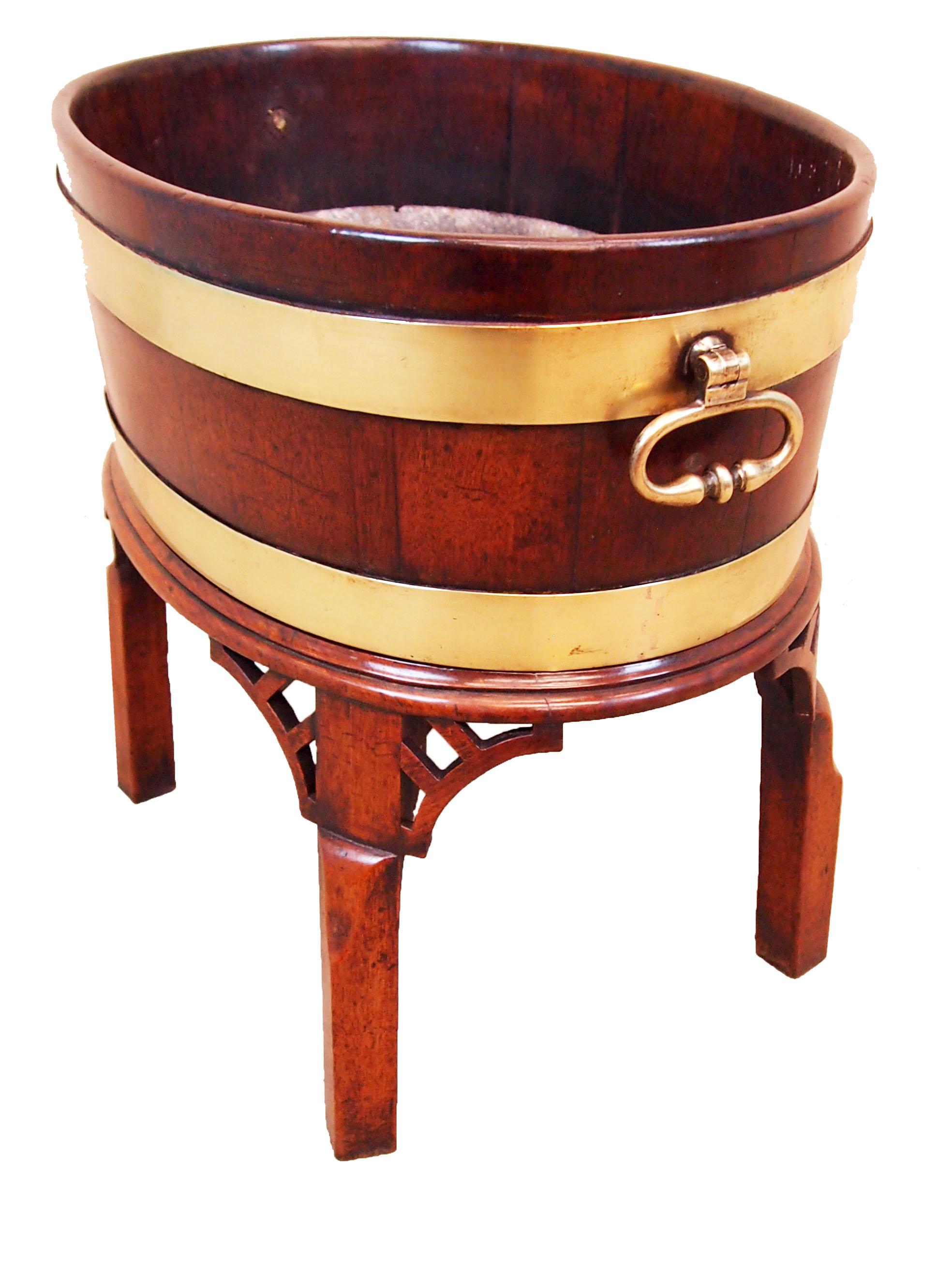 A delightful 18th century mahogany oval open wine
Cooler having original brass bound decoration and
Original brass carrying handles housed on original
Square leg stand with pierced corner brackets

(This beautiful oval wine cooler is raised on