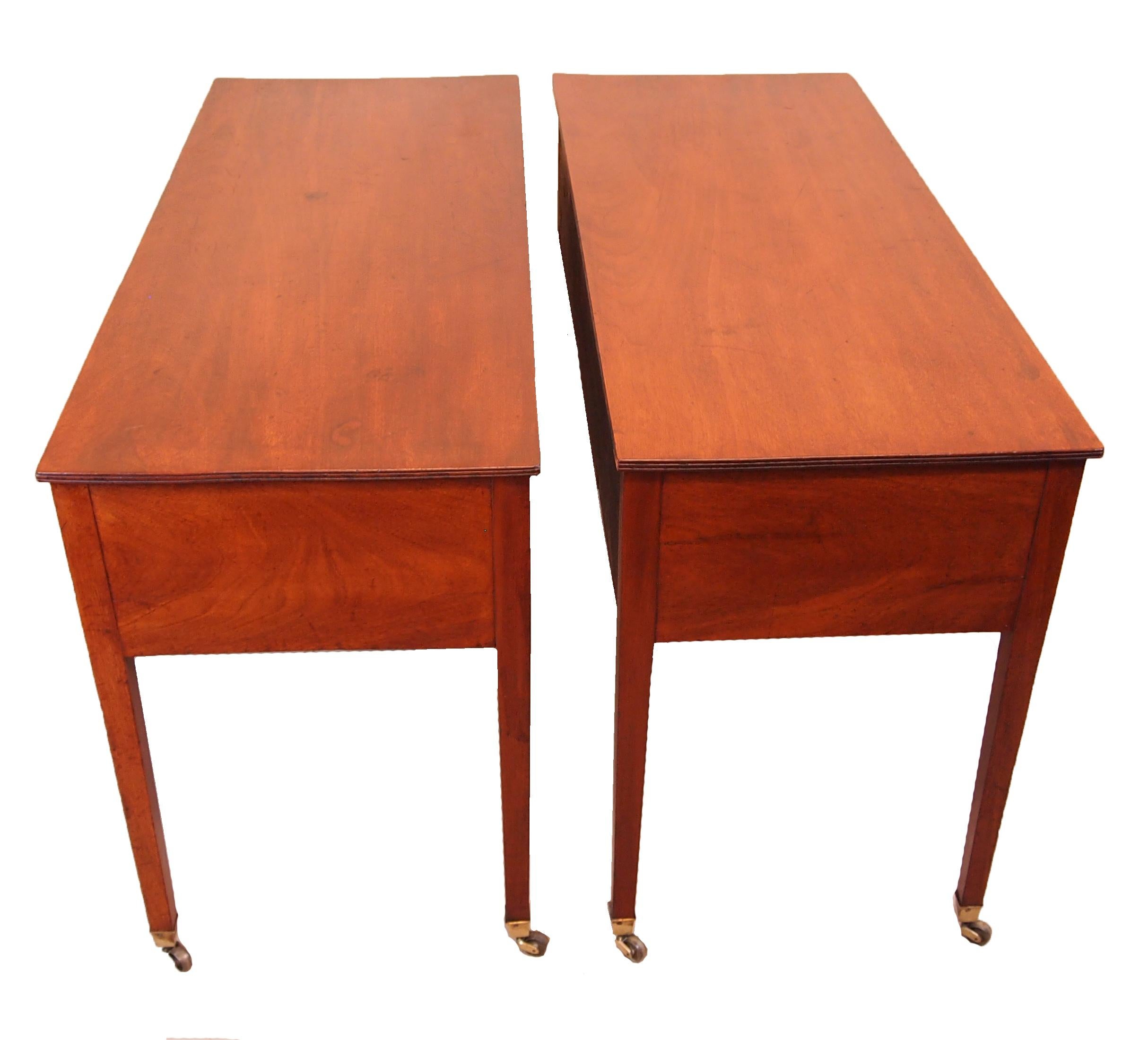 An extremely rare pair of George III period mahogany
dressing tables having well figured tops above three
frieze drawers raised on elegant square tapered legs.