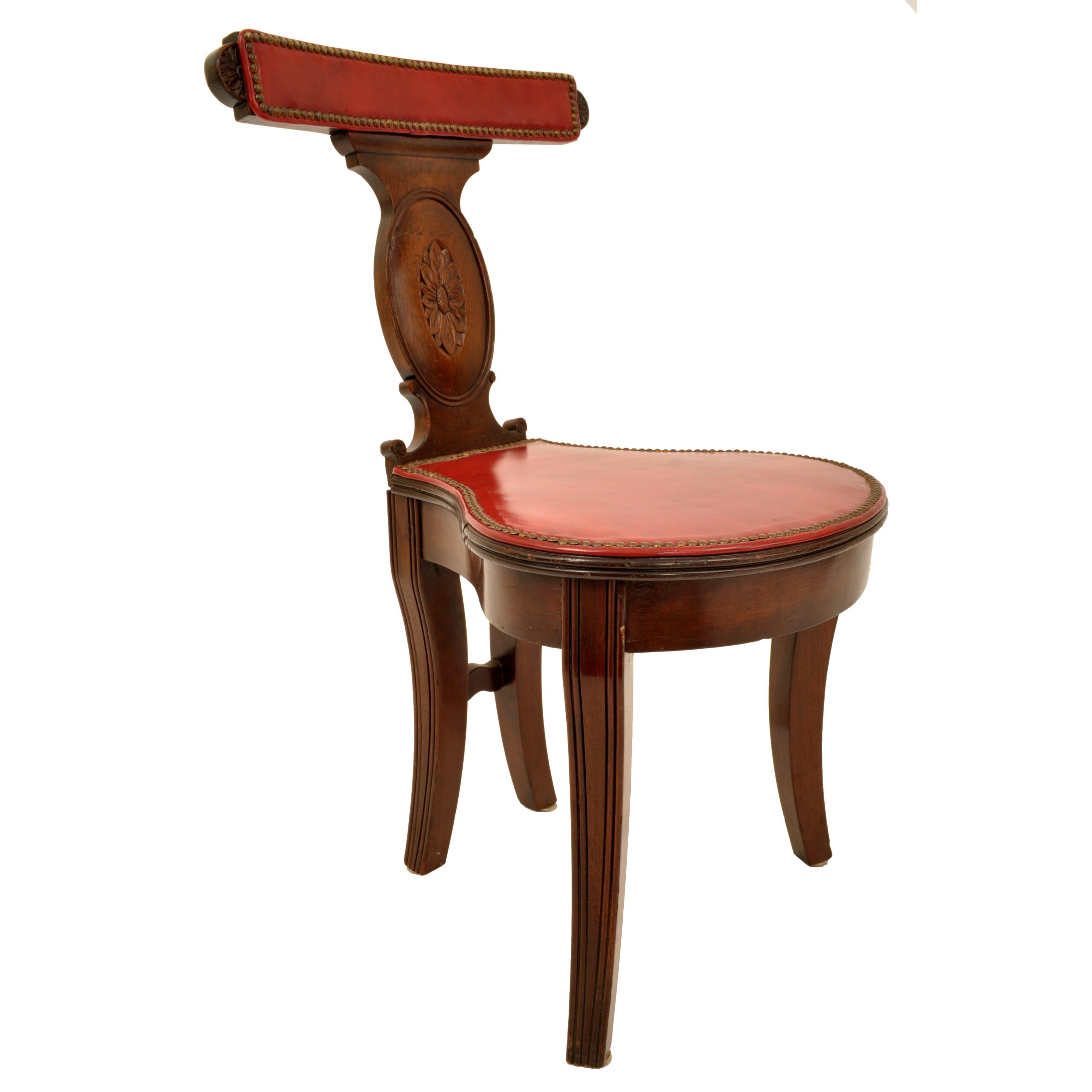 A good antique Georgian mahogany & red leather library/cockfighting or gambler's chair, circa 1800.
The chair designed for the sitter to sit facing the back of the chair, both the seat and backsplat having red leather with brass studwork. The back