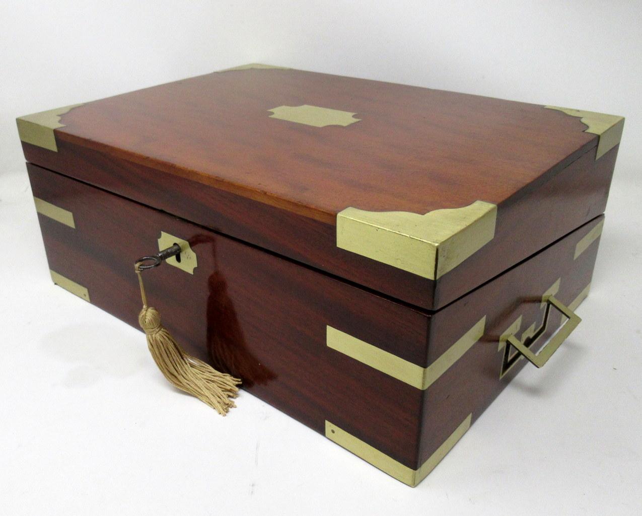 An exceptionally fine quality English well figured solid mahogany ladies or gents travelling writing slope of outstanding quality and medium proportions, with unusual moulded brass inlay decoration, flush side carrying handles and central canted