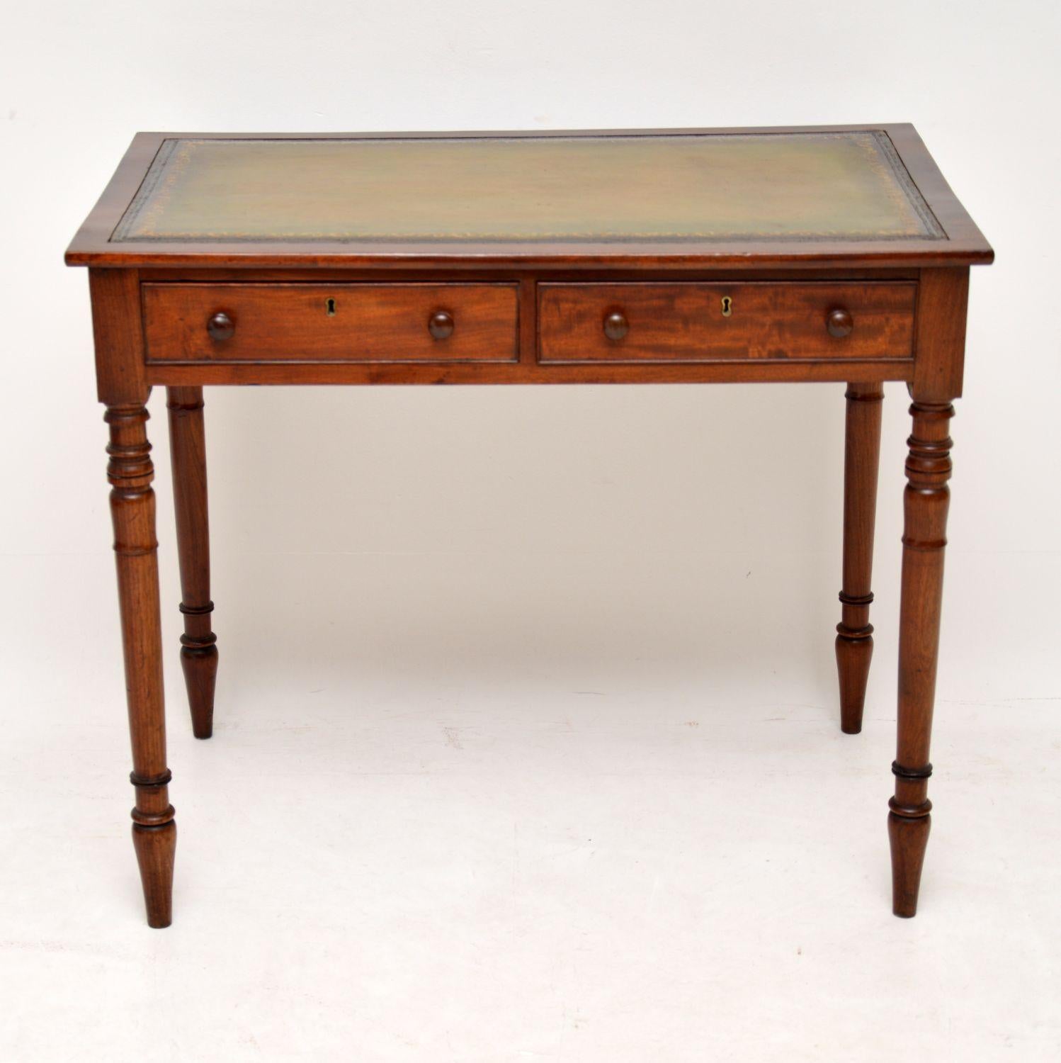 This is a very neat small antique writing table from circa 1800s-1820s period & what’s particularly nice about it is that it’s two sided, with dummy drawers on the back. It’s mahogany with a tooled leather writing surface & two drawers on the front