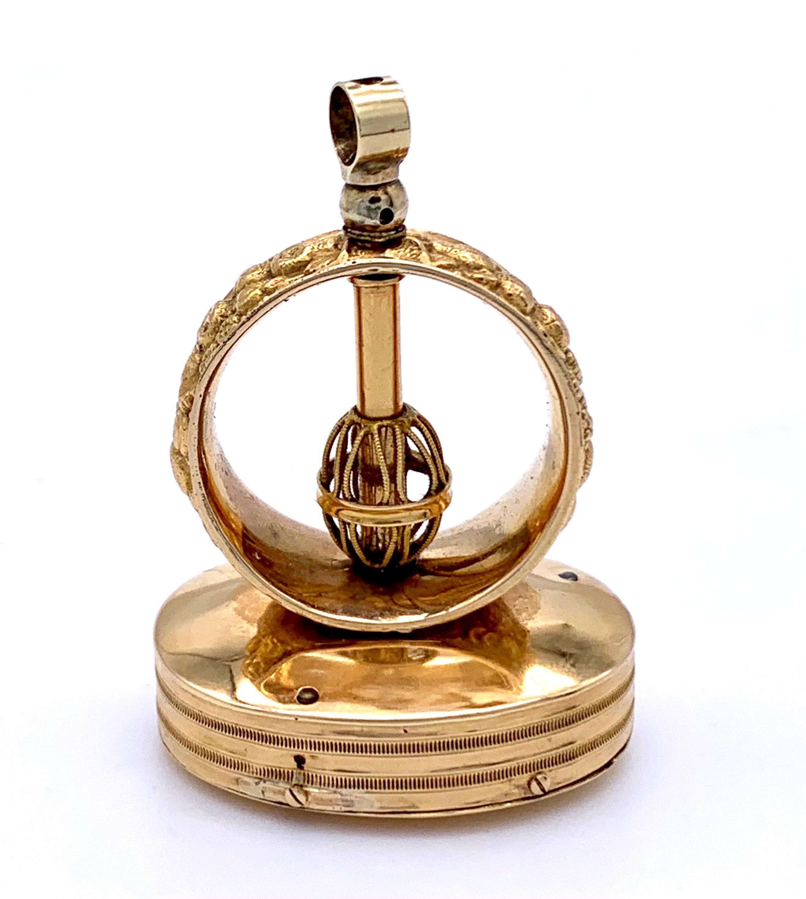 This rare novelty pendant used to grace the watchchain of a nobleman. The mechanical rarity plays a little tune and is in fine working order. The finely embossed outer shell is made out of 15 carat gold, the mecanism out of metal.