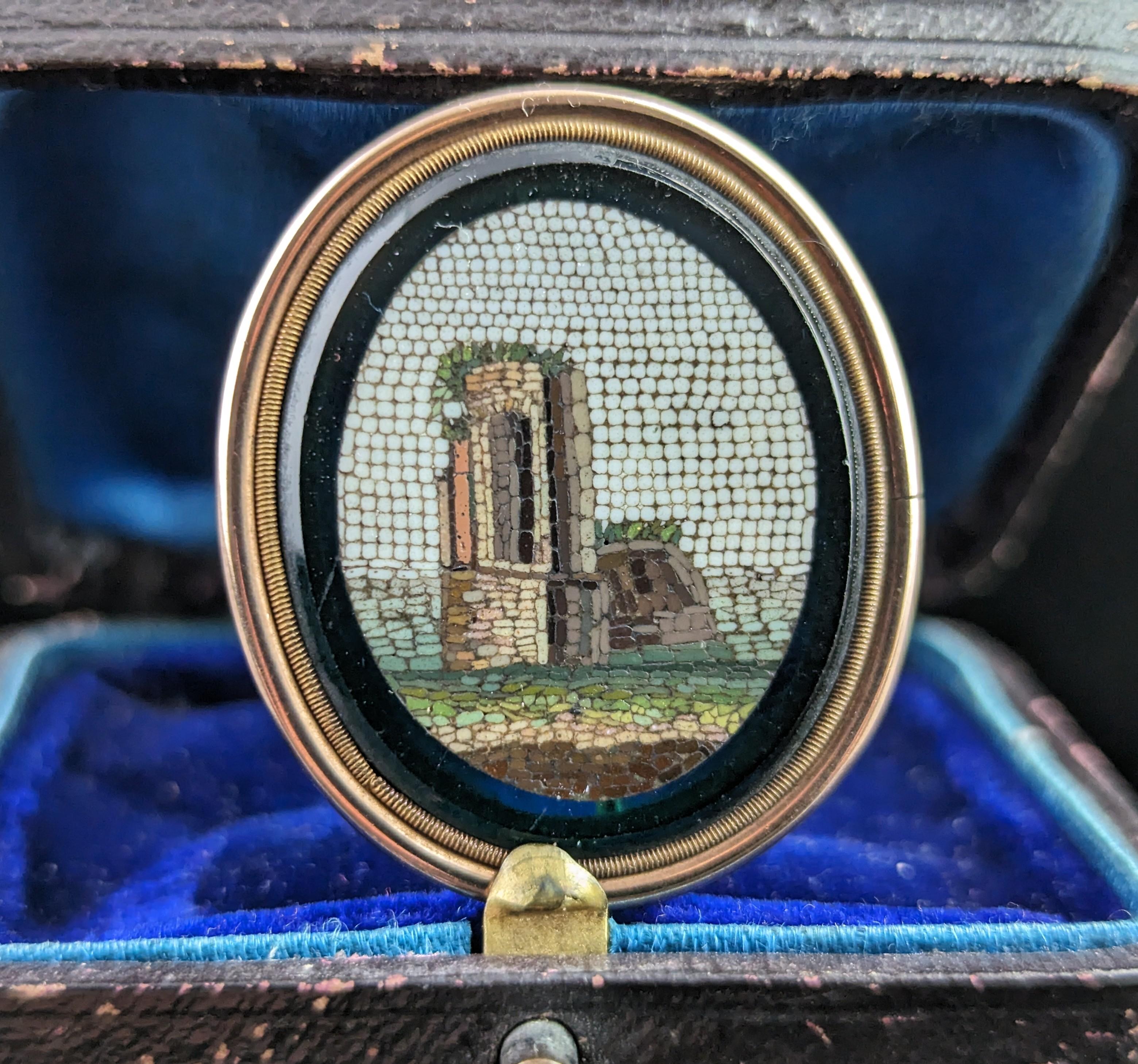 The charm and wonder of antique micro mosaics is second to none.

This antique Micro Mosaic brooch is an early 19th century, Georgian Grand Tour piece, designed for the tourist market in Italy that boomed in the era.

The brooch is made up with a