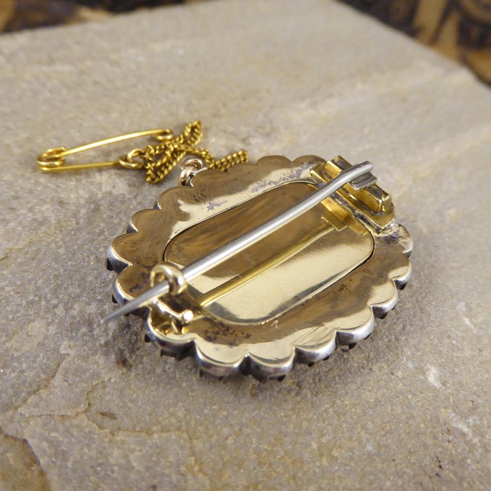 This beautiful memorial locket Brooch is studded with 18 Rose cut Paste stones all in slightly different colours with a fully closed Silver back. Under a piece of glass on the front of the Brooch, holds woven human hair with a detailed 9ct yellow