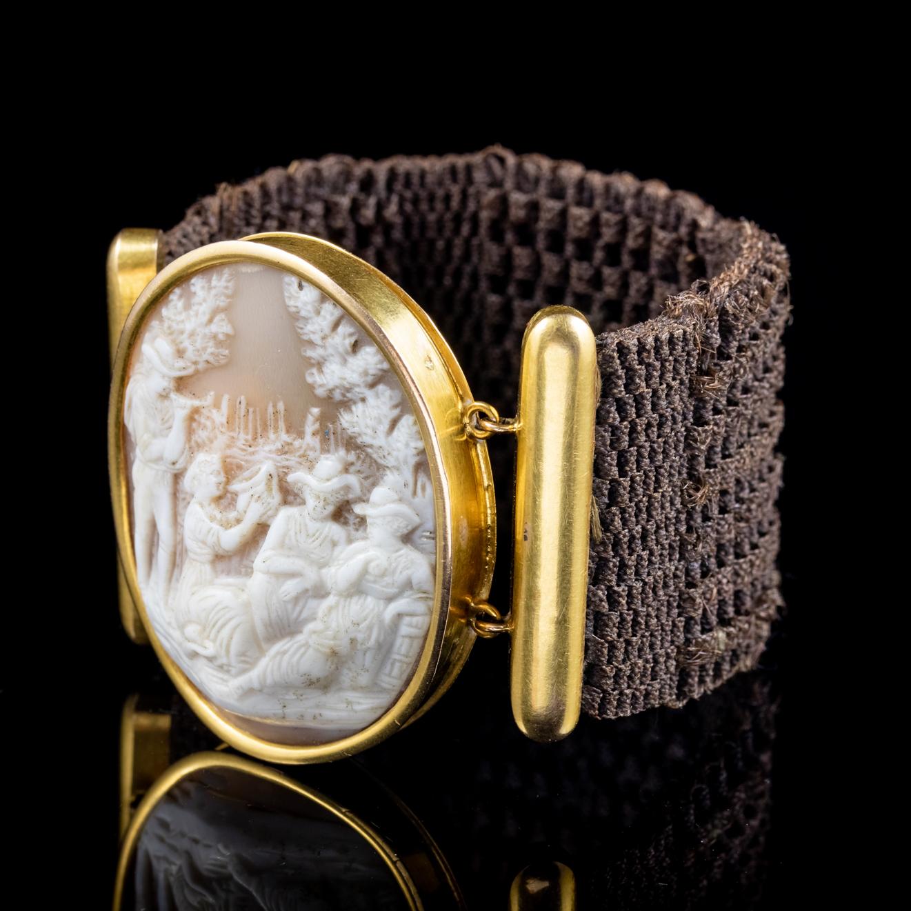 A wonderful antique Georgian Mourning bracelet featuring a carved bullmouth shell Cameo fitted to a lovely band made up of fine brown hair which has been intricately woven into tight plaits to create this wonderful elastic band that can stretch to