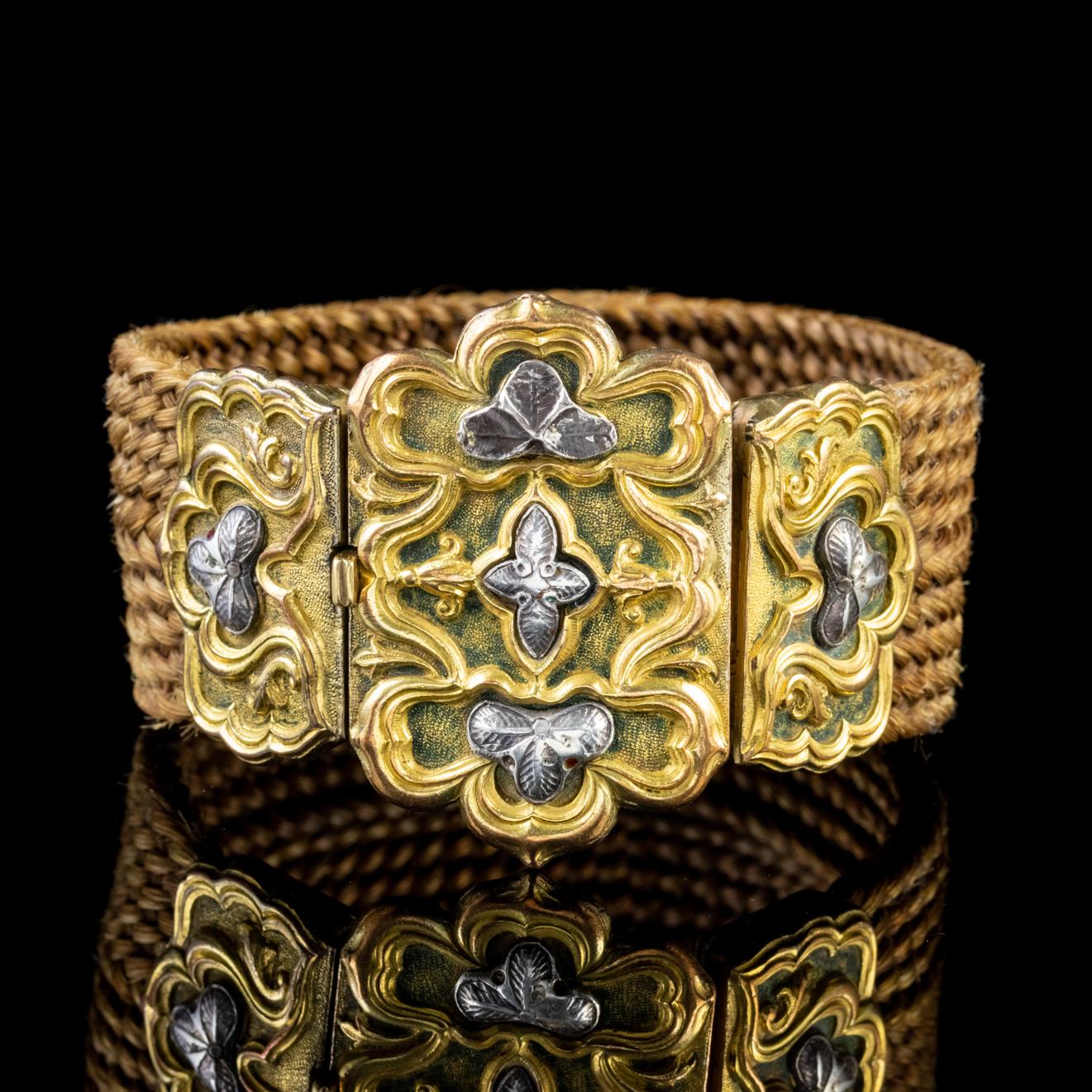 This grand antique Georgian Mourning bracelet features a thick band of braided hair which is tightly woven and a lovely shade of golden brown. 

Mourning jewellery mirrored the lives and times of the people who wore it. It was a souvenir to remember