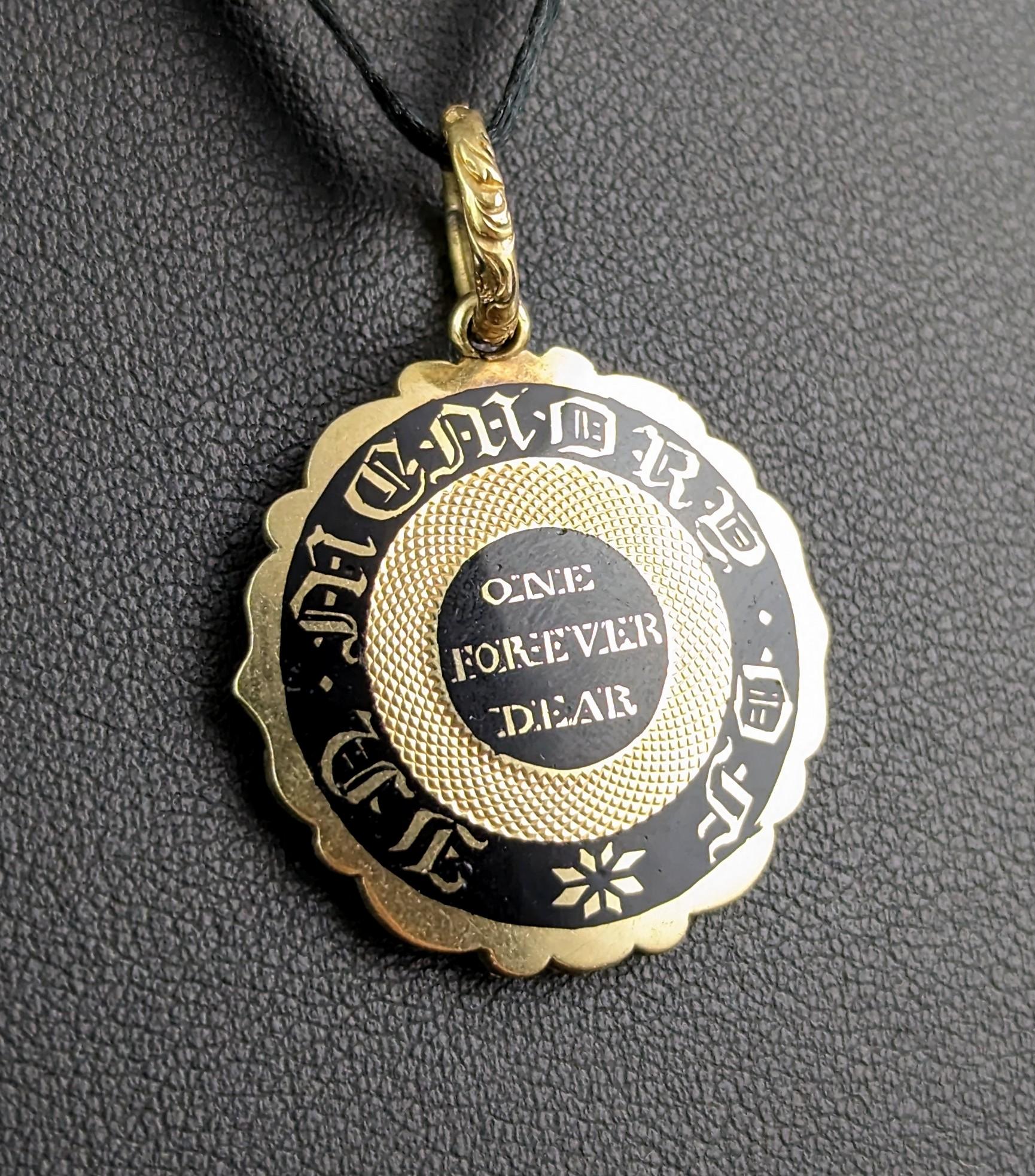 This antique Georgian mourning locket is mesmerisingly beautiful!

Late Georgian era, it is a circular shaped locket pendant with a scrolling edge and the most charming chased and engraved bale.

The front of the pendant is decorated in rich black