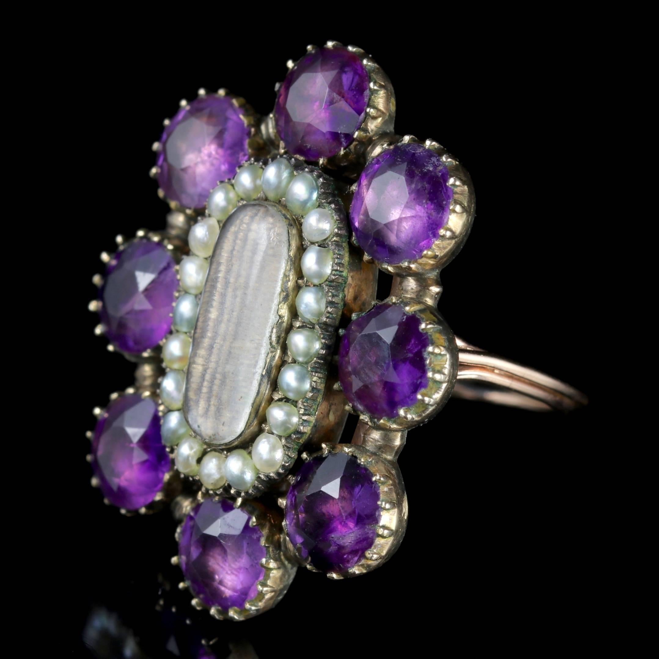To read more please click continue reading below-

This fabulous large antique Amethyst Pearl Mourning ring is a genuine Georgian piece, Circa 1800. 

A halo of Pearls and old cut Amethyst stones chase around the central piece which displays