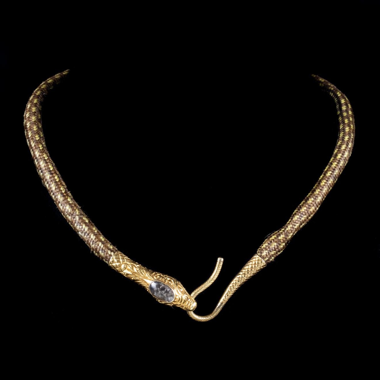 An exquisite antique Mourning snake necklace from the Georgian era made up of three different shades of lovely brown hair which is plaited beautifully to create one thick strand.

Mourning jewellery was sometimes created from strands of hair and was