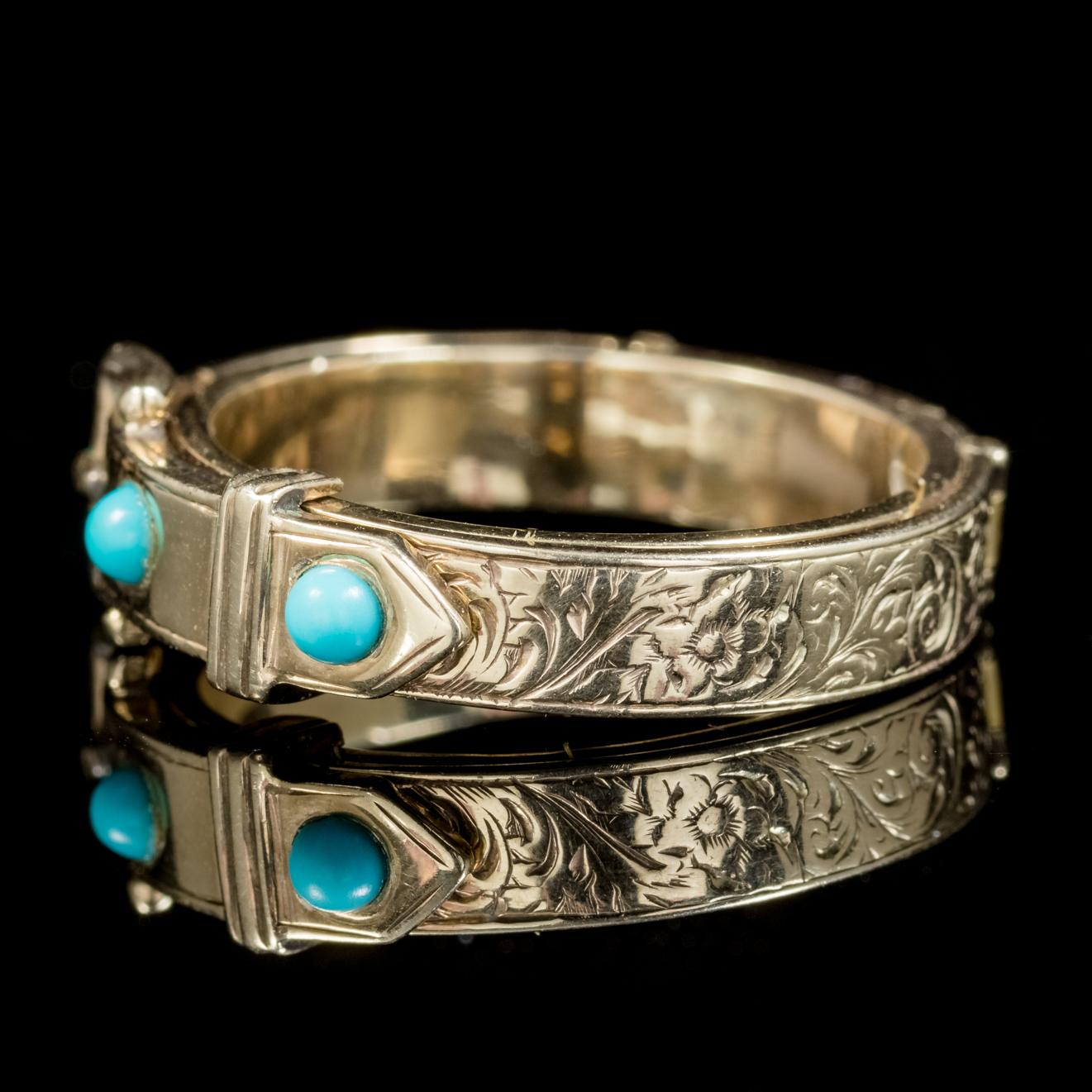 A grand antique Mourning buckle ring from the Georgian era, Circa 1800. 

The piece is beautifully designed with an engraved buckle at the front crowned with two Turquoise stones. 

The buckle also unclips and opens up to reveal a fabulous display