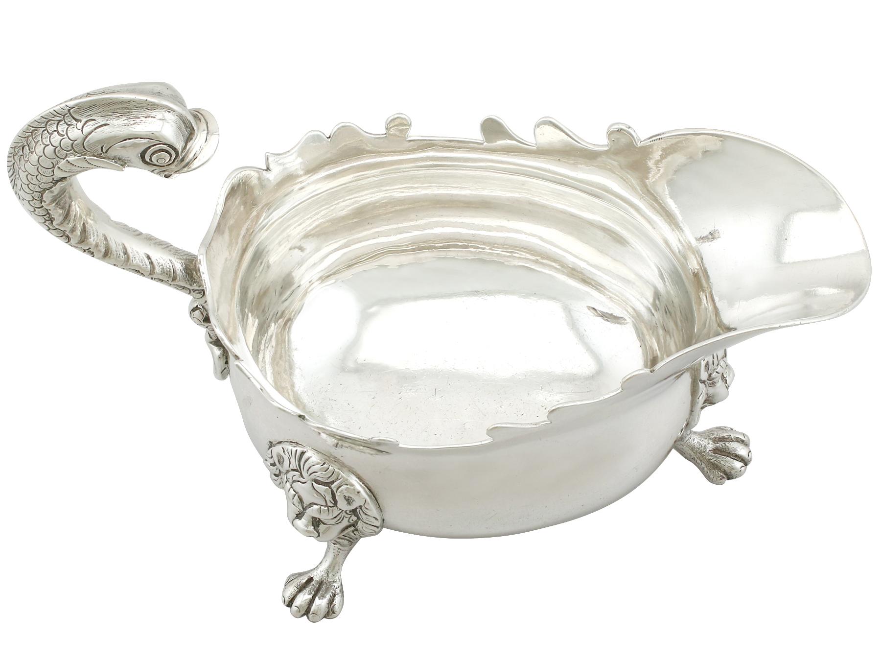 An exceptional, fine and impressive, antique Georgian Newcastle sterling silver sauce or gravy boat, part of our dining silverware collection.

This exceptional antique George II sterling silver sauceboat has a plain oval rounded form onto three